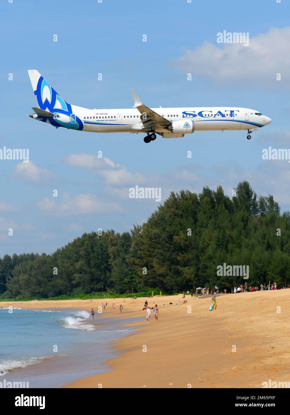 SCAT Airlines Boeing 737-9 MAX airplane flying over beach. Aircraft 737 MAX of Scat Airlines over Mai Khao Beach. Plane 737 MAX UP-B3726. Stock Photo