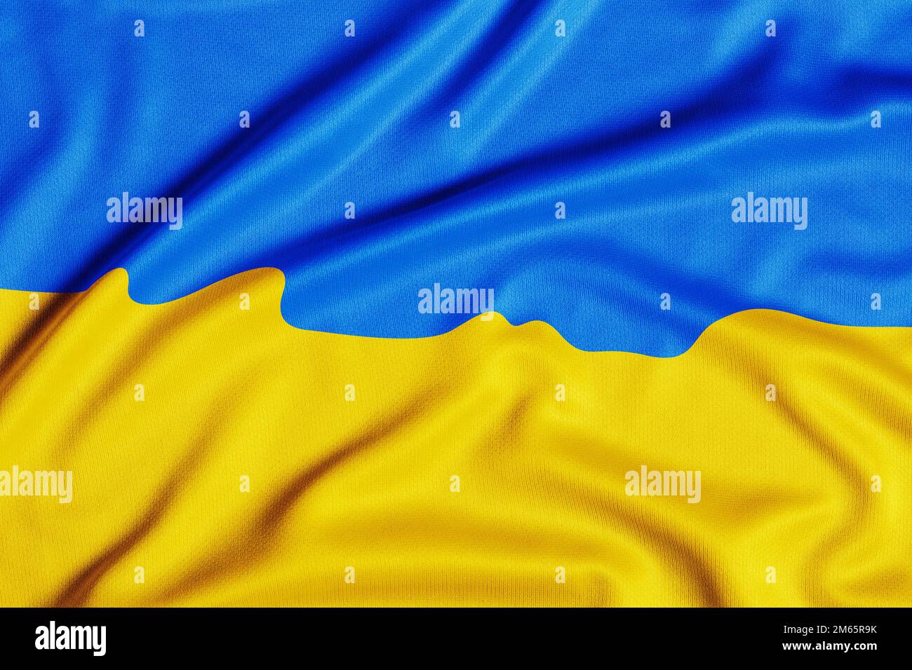 Fabric curved flag of Ukraine, UA. Blue and yellow colors. Close up