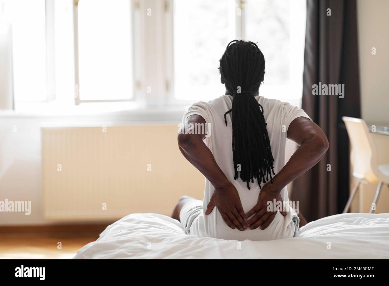 Black Man Suffering Lower Back Pain After Sleeping In Bed