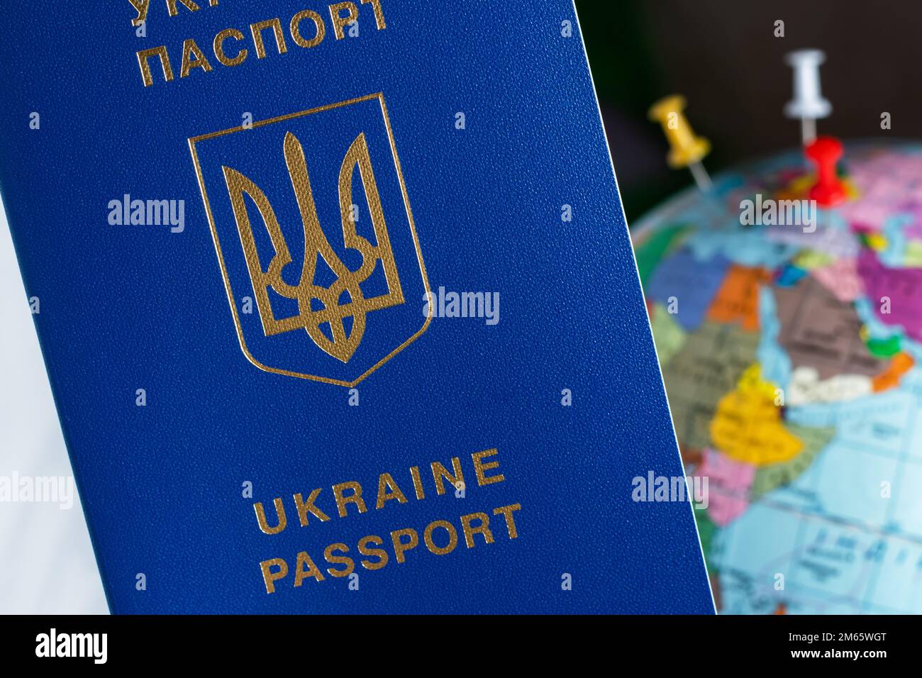 Ukraine Passporton The Background Of The Globe Ukrainian Passports In Hands Are On The World 4794