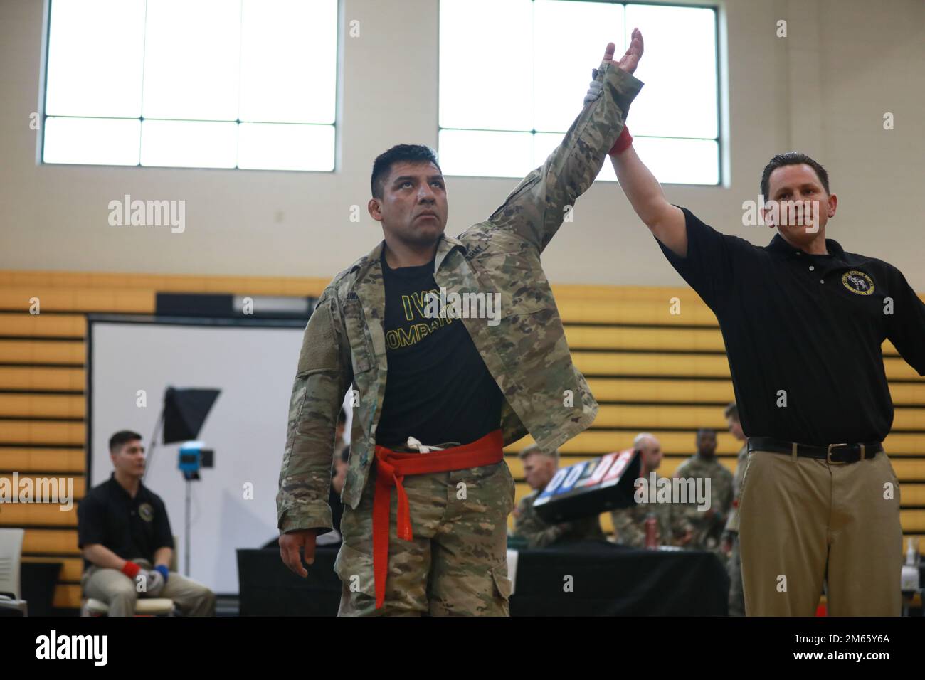 U.S. Army Staff Sgt. Efrain Luna, an aircraft power plant repairer with 404th Aviation Support Battalion, 4th Combat Aviation Brigade, 4th Infantry Division, has his arm raised after defeating his opponent on day 1 of the 2022 All Army Combatives Championship, Lacerda Cup, at Fort Benning, Georgia, April 5. The combatives competition is named in honor of the late Staff. Sgt. Pedro Lacerda of the 75th Ranger Regiment, and recognizes outstanding performance in hand-to-hand fighting skills known in the Army as combatives. Stock Photo
