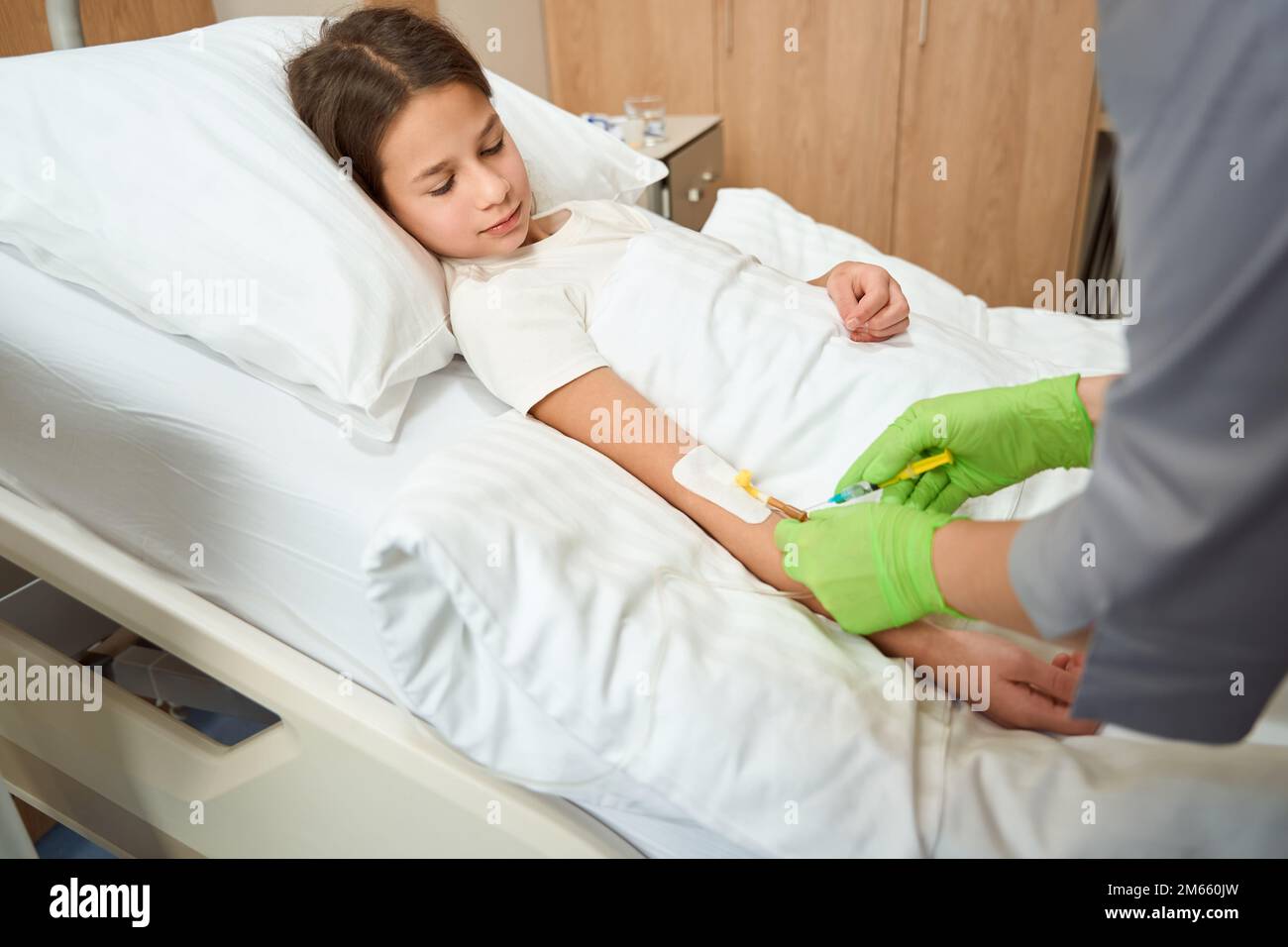 Medical worker performs a medical manipulation on a small patient Stock