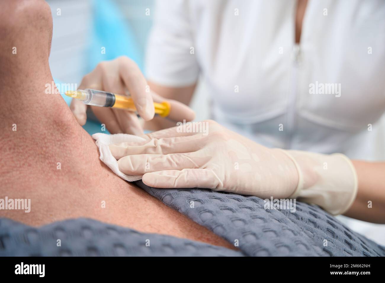Well-trained medic performing a skin rejuvenation injection for clinic ...