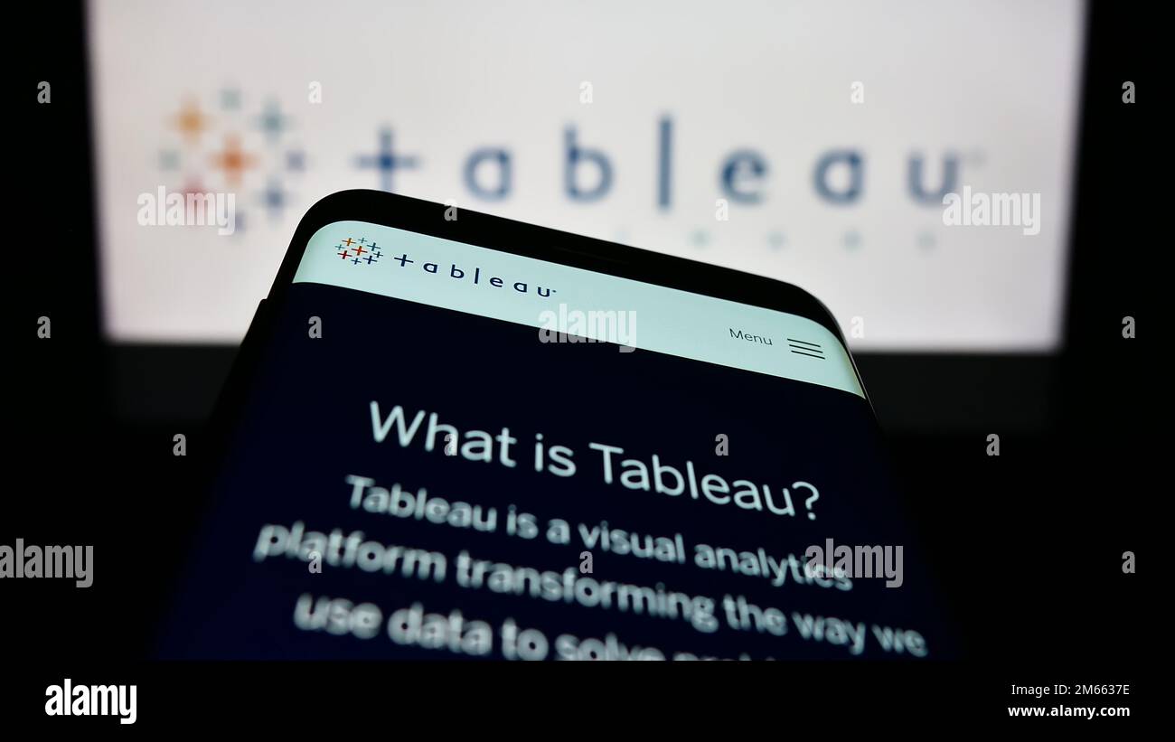 Mobile phone with website of US company Tableau Software Inc. on screen in front of business logo. Focus on top-left of phone display. Stock Photo
