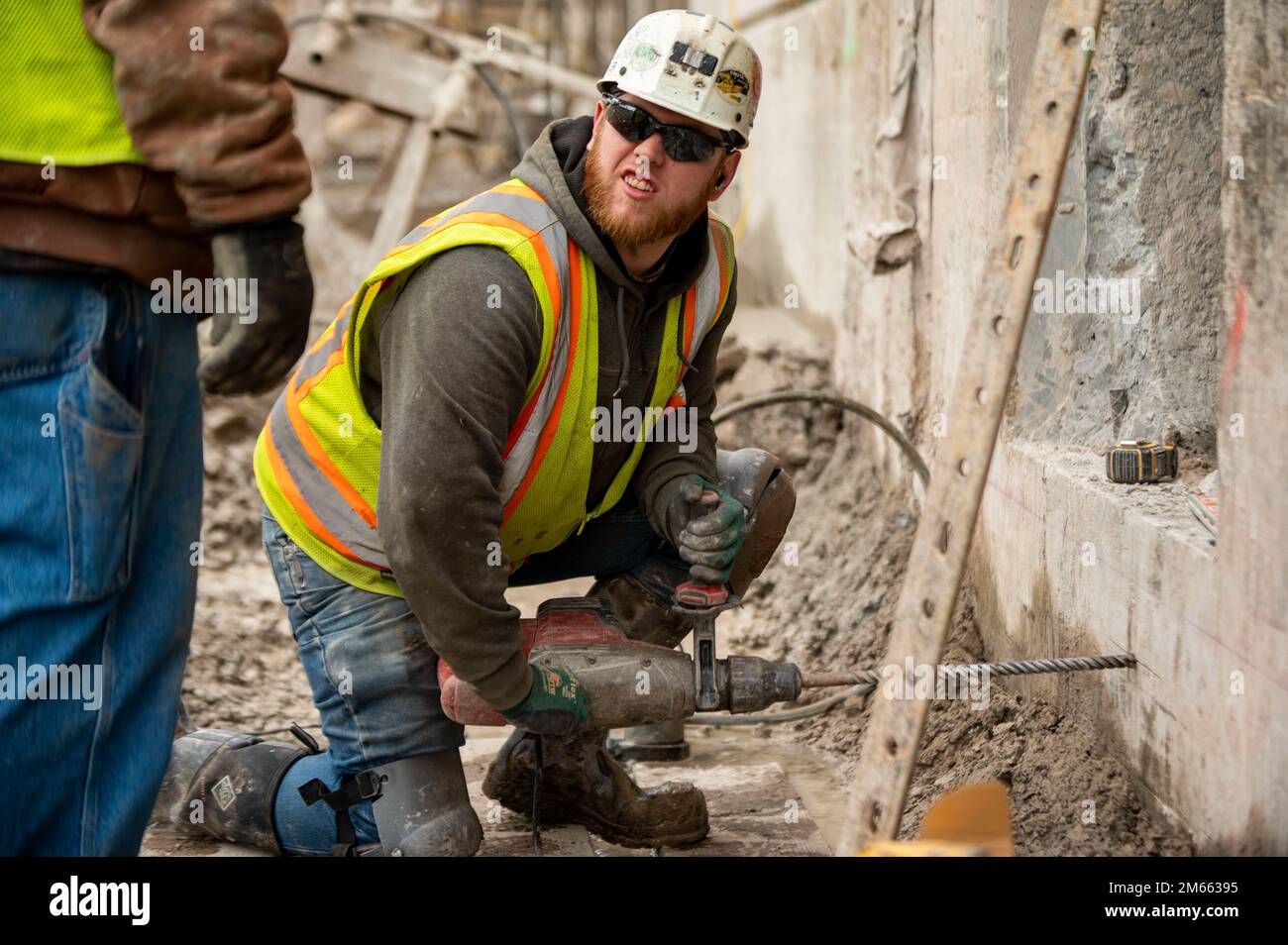 Jeremy Clevenger, a carpenter, drills holes to prepare a concrete form