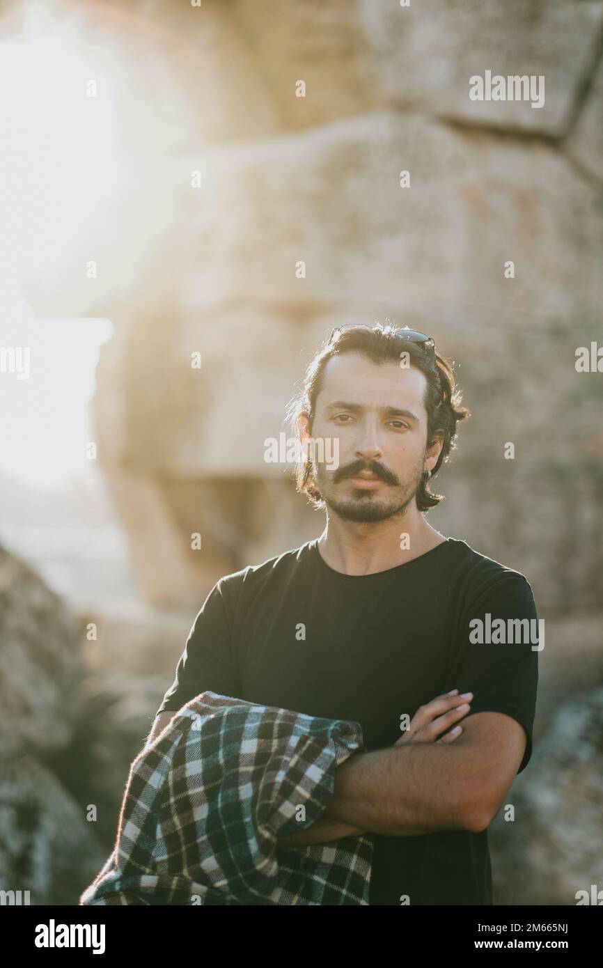 Young handsome man posing in front of ancient ruins Stock Photo