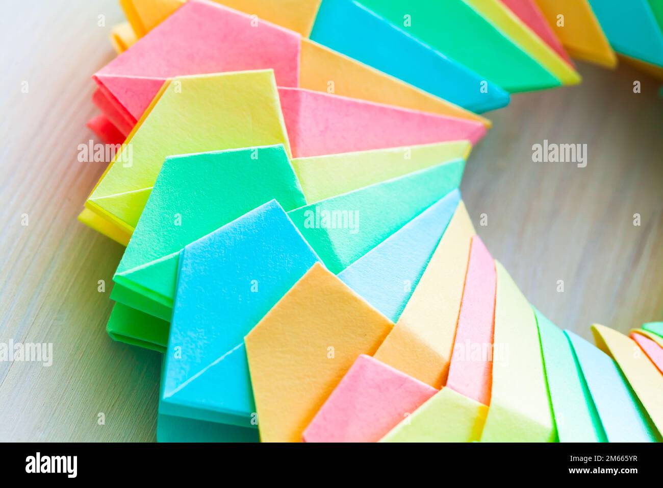 Colorful origami ring on a white table background, abstract parametric ...
