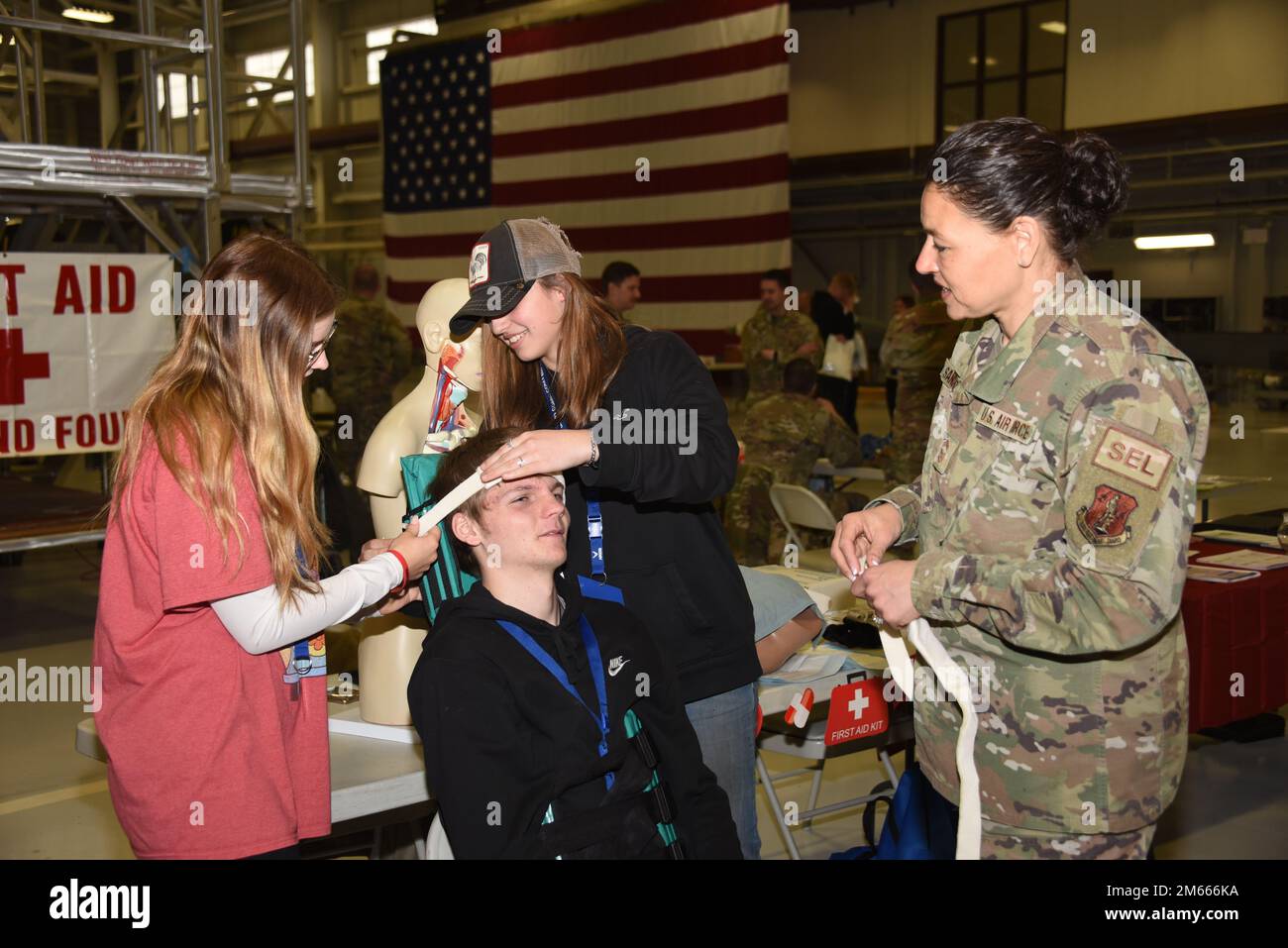 Chief Master Sgt. Mellisa Sanchez, 185th Air Refueling Wing Medical Group Superintendent demonstrates spine stabilization on a student who is attending a career fair at the 185th ARW in Sioux City, Iowa on April 6, 2022. U.S. Air National Guard photo by A1C Olivia Monk. Stock Photo