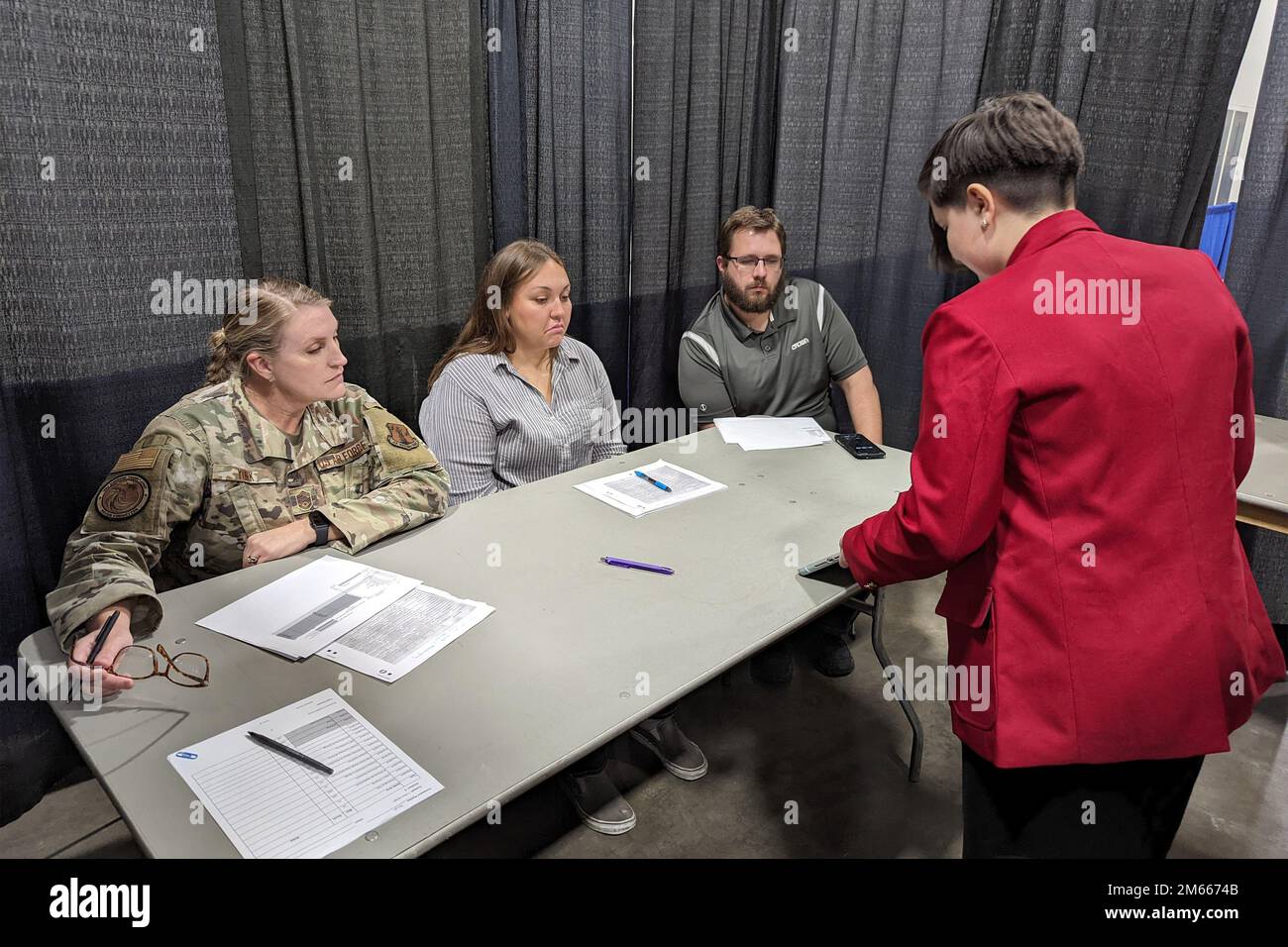 U.S. Air Force Senior Master Sgt. Shannon Yunk, administrative superintendent for the Air National Guard's 115th Fighter Wing, joins a panel of judges for the t-shirt design competition at the SkillsUSA State Leadership and Skills Conference in Madison, Wisconsin, April 6, 2022. Each year Wisconsin Air National Guard members from a variety of occupational specialties leverage their military training and experience to serve as judges for the annual event, which helps prepare area students for careers in trade, technical and skilled service occupations. Stock Photo