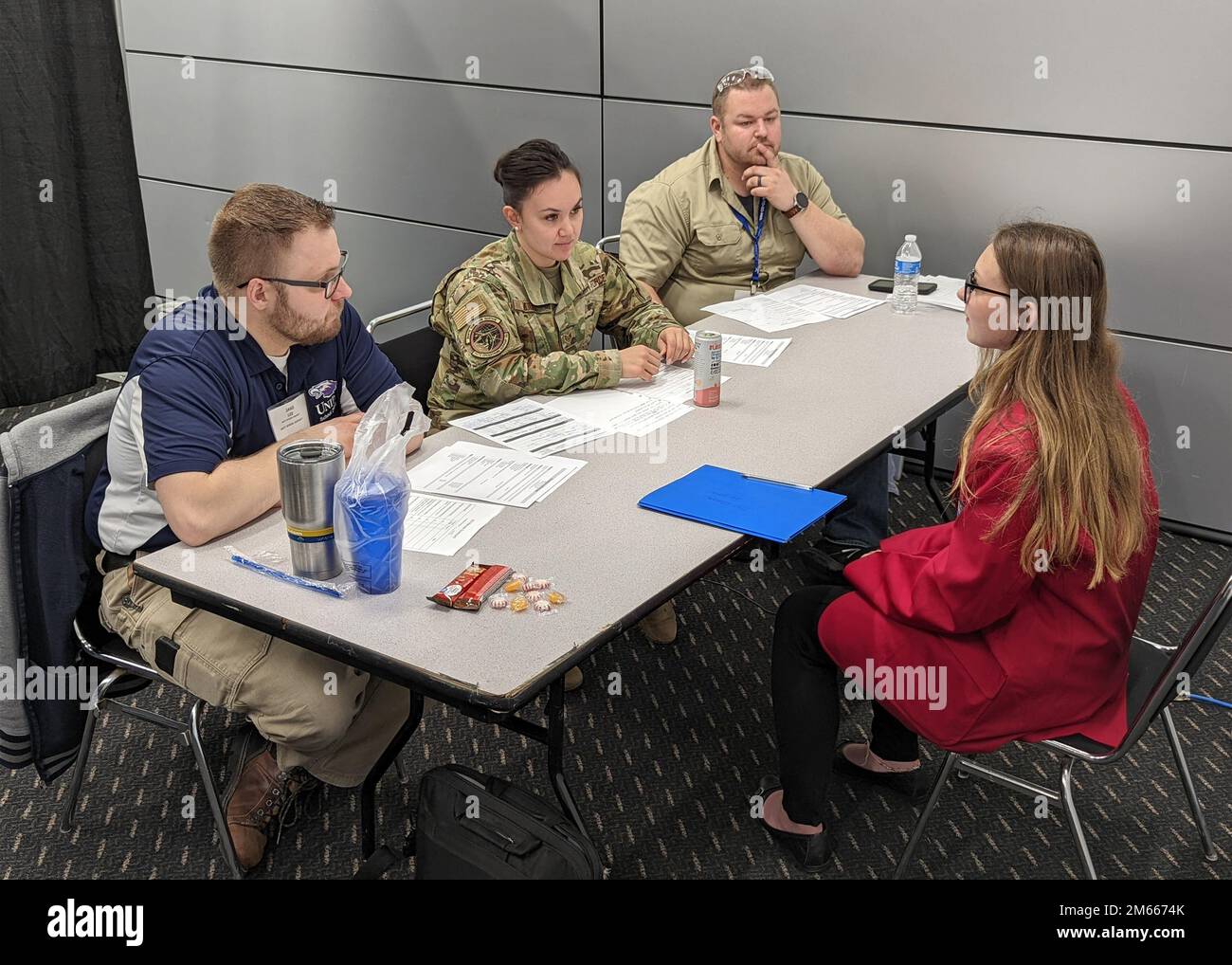 U.S. Air Force Technical Sgt. Katherine Moore, aircrew flight equipment specialist for the 115th Fighter Wing's Operations Support Squadron, helps to form a hiring board for the job interview competition at the SkillsUSA State Leadership and Skills Conference in Madison, Wisconsin, April 6, 2022. Each year Wisconsin Air National Guard members from a variety of occupational specialties leverage their military training and experience to serve as judges for the annual event, which helps prepare area students for careers in trade, technical and skilled service occupations. Stock Photo