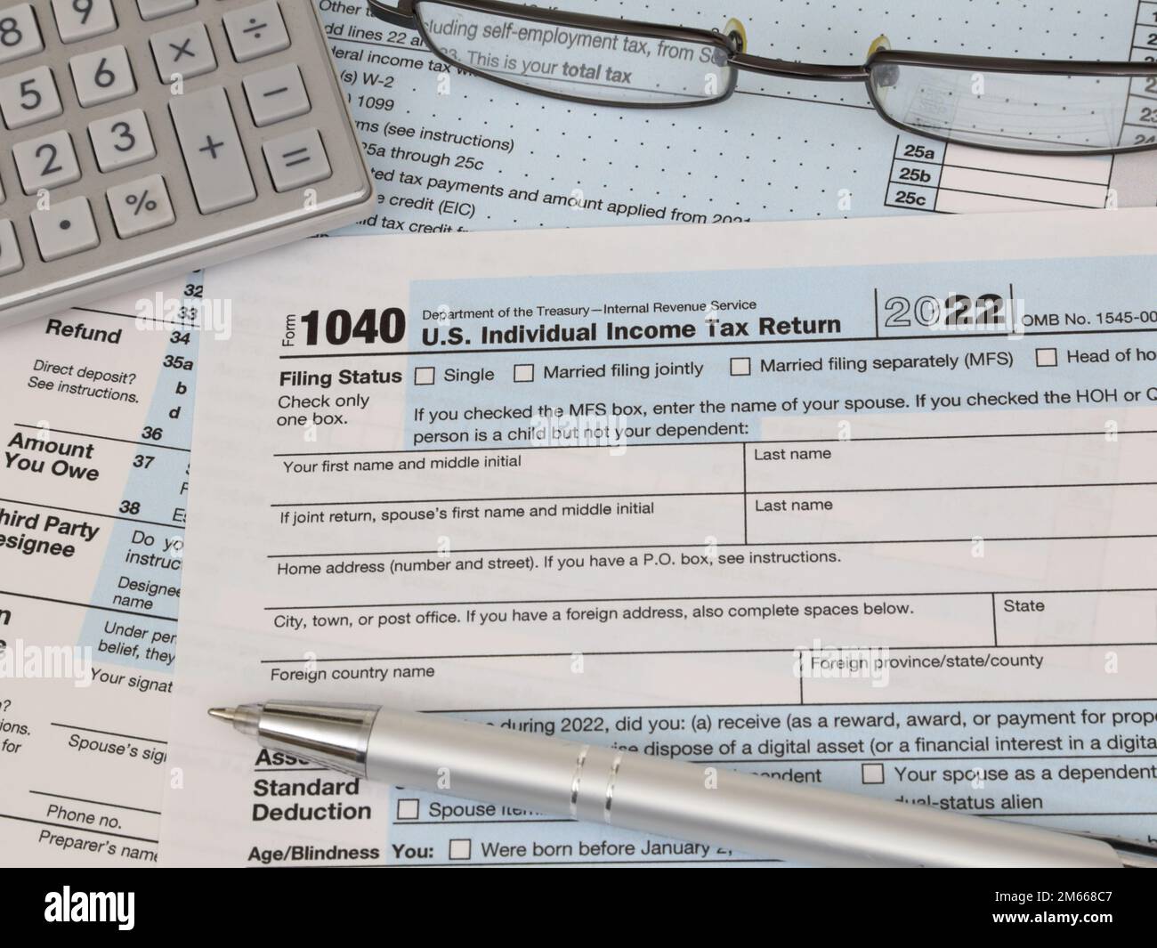 An IRS 1040 Tax Year 2022 Form Is Shown Along With An Ink Pen