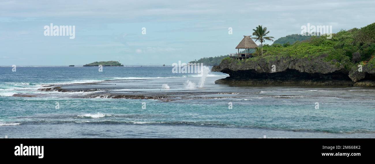 Blowhole and hut on a tropical island in Fiji Stock Photo