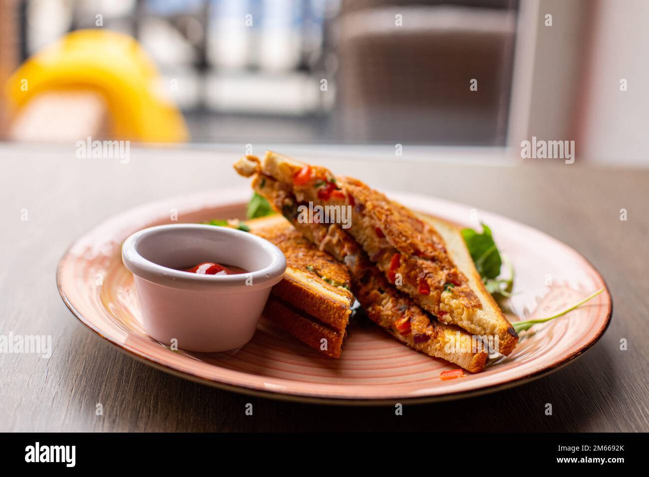 Roast, fried club sandwich with meat, ham, cheese, greenery, eggs