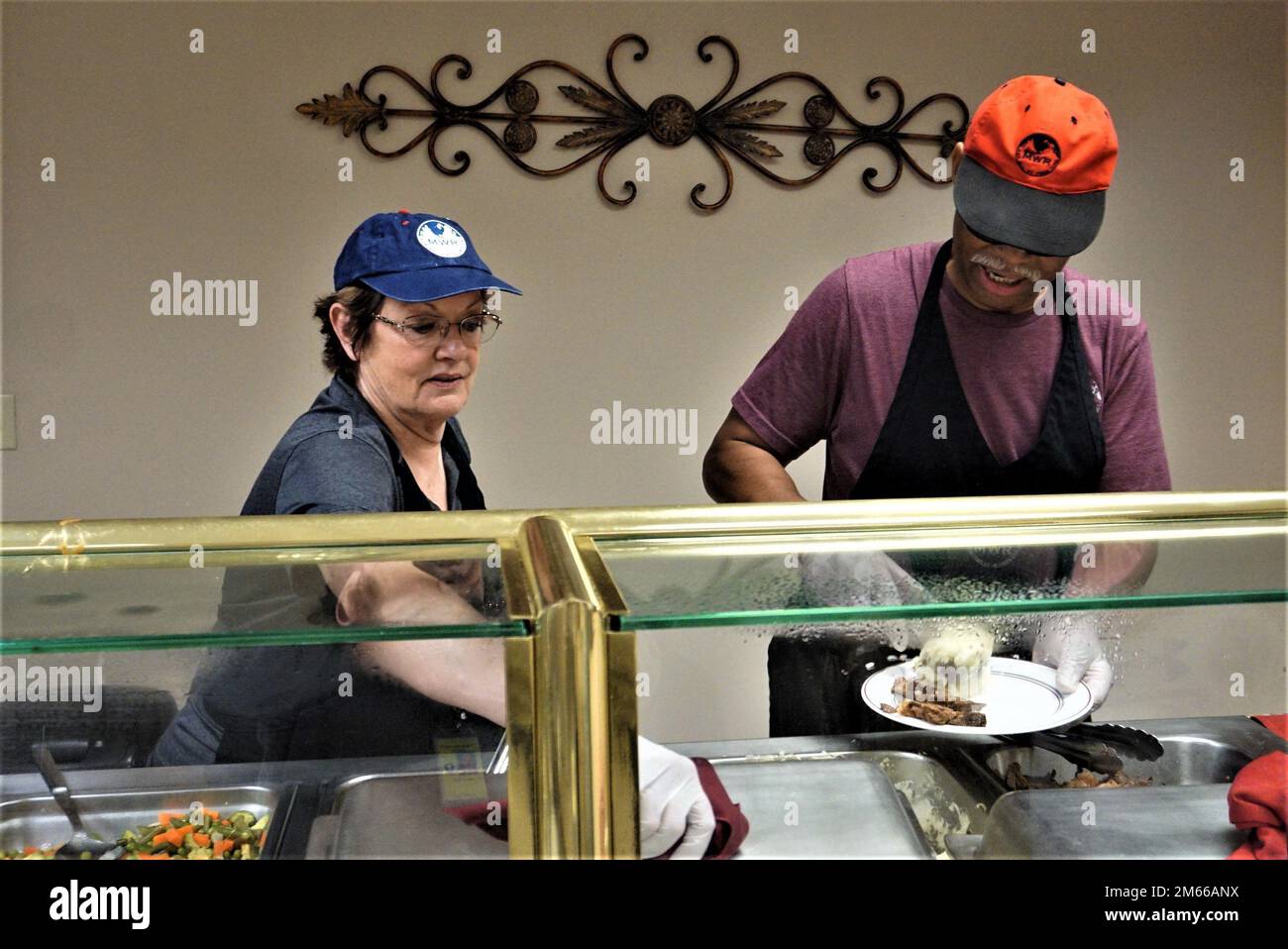 Kim Smith (right) and Donna Lilly (left), MWR employees, serving food to Soldiers of the 63rd Ordnance Company and 118th Transportation Company (TC) at the Eagles Nest Dining Facility at Tooele Army Depot (TEAD) on April 06, 2022. Stock Photo