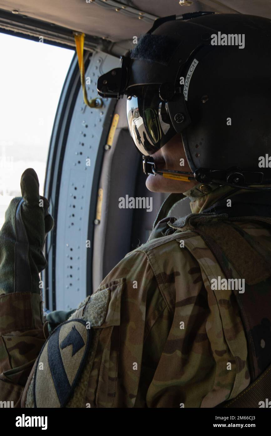 U.S. Army Spc. James Rydalch, assigned to 1st Air Cavalry Brigade, 1st  Cavalry Division, gives a thumbs up to a fellow Soldier before taking  flight for aerial gunnery training at Novo Selo