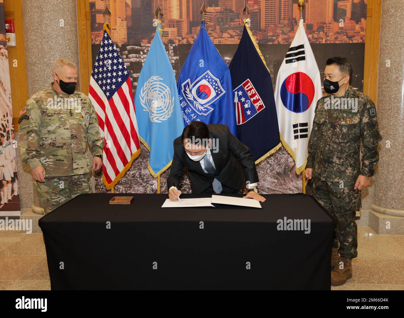 Republic of Korea President-elect Yoon, Suk-yeol signs a guest book accompanied by Gen. Paul J. LaCamera, United Nations Command, Combined Forces Command, U.S. Forces Korea Commander, and ROK Gen. Kim, Seung-kyum, CFC Deputy Commander at Camp Humphreys, Republic of Korea, April 7, 2022. President-elect Yoon visited Humphreys to receive an overview of UNC/CFC/USFK’s ironclad commitment to strengthening the US-ROK Alliance and providing a strong robust combined defense posture to maintaining peace, security, and stability of the Korean peninsula. Stock Photo