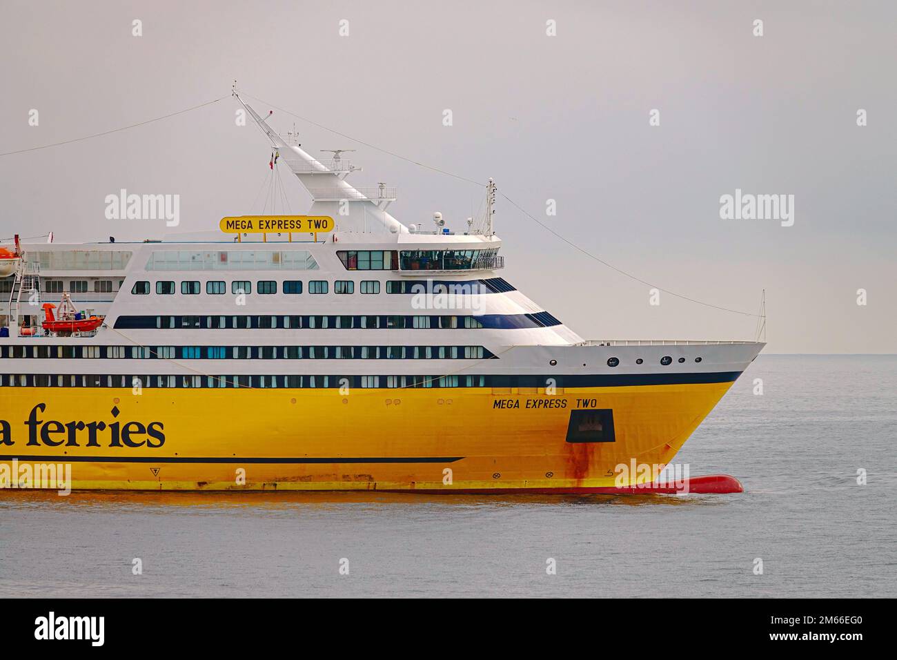 View of a yellow ferryboat Corsica Sardinia Ferries in the Port of Nice harbor. Nice, France - December 2022 Stock Photo