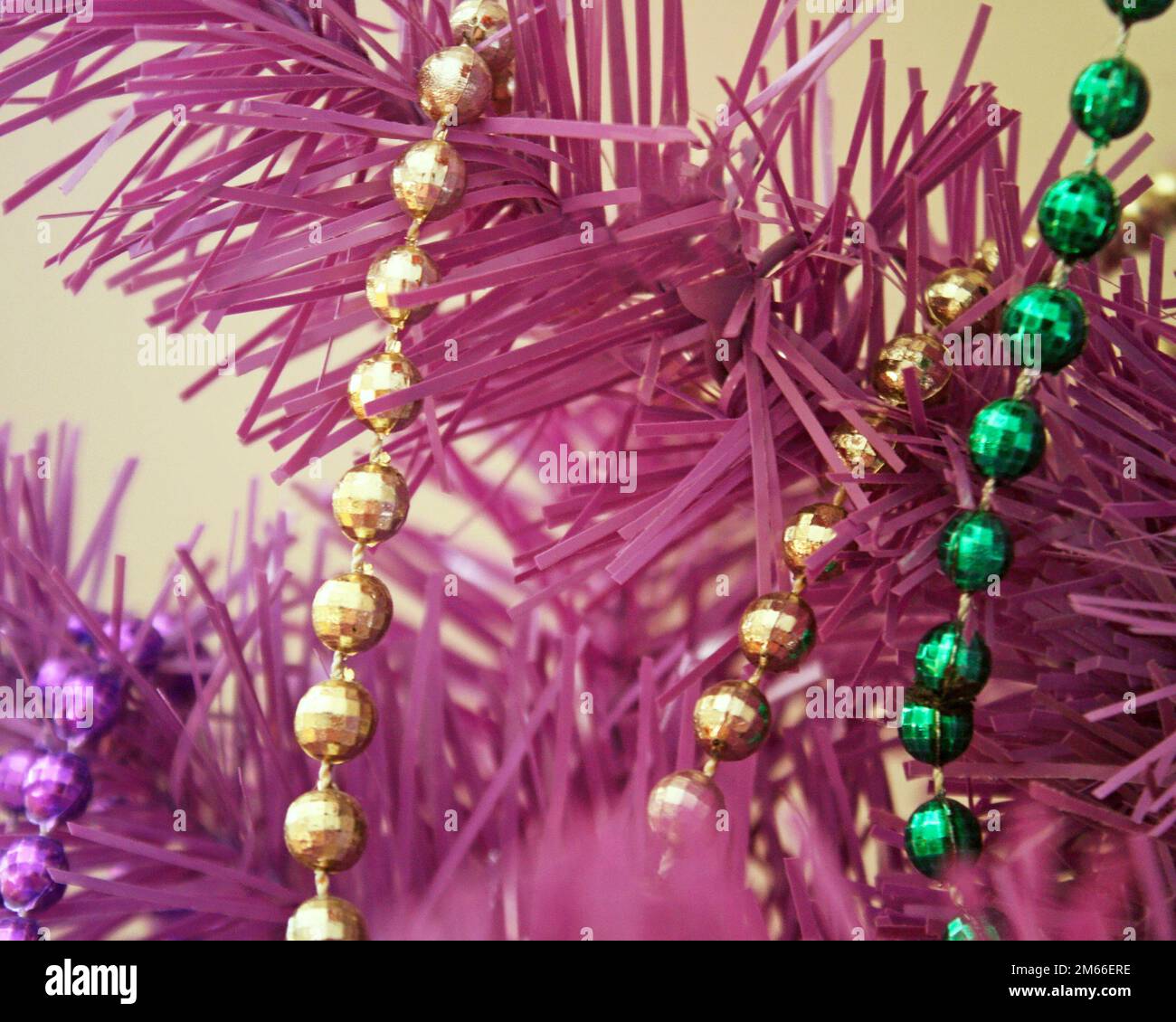 Strands of beads in gold and green draped over the branches of an