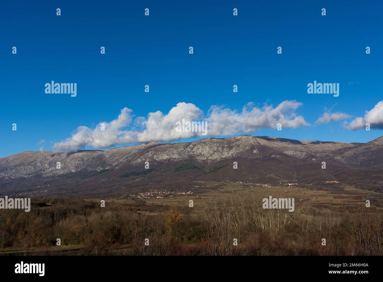 Stunning landscape view of Suva Planina, featuring the entire mountain and the surrounding autumn forest on a sunny day Stock Photo