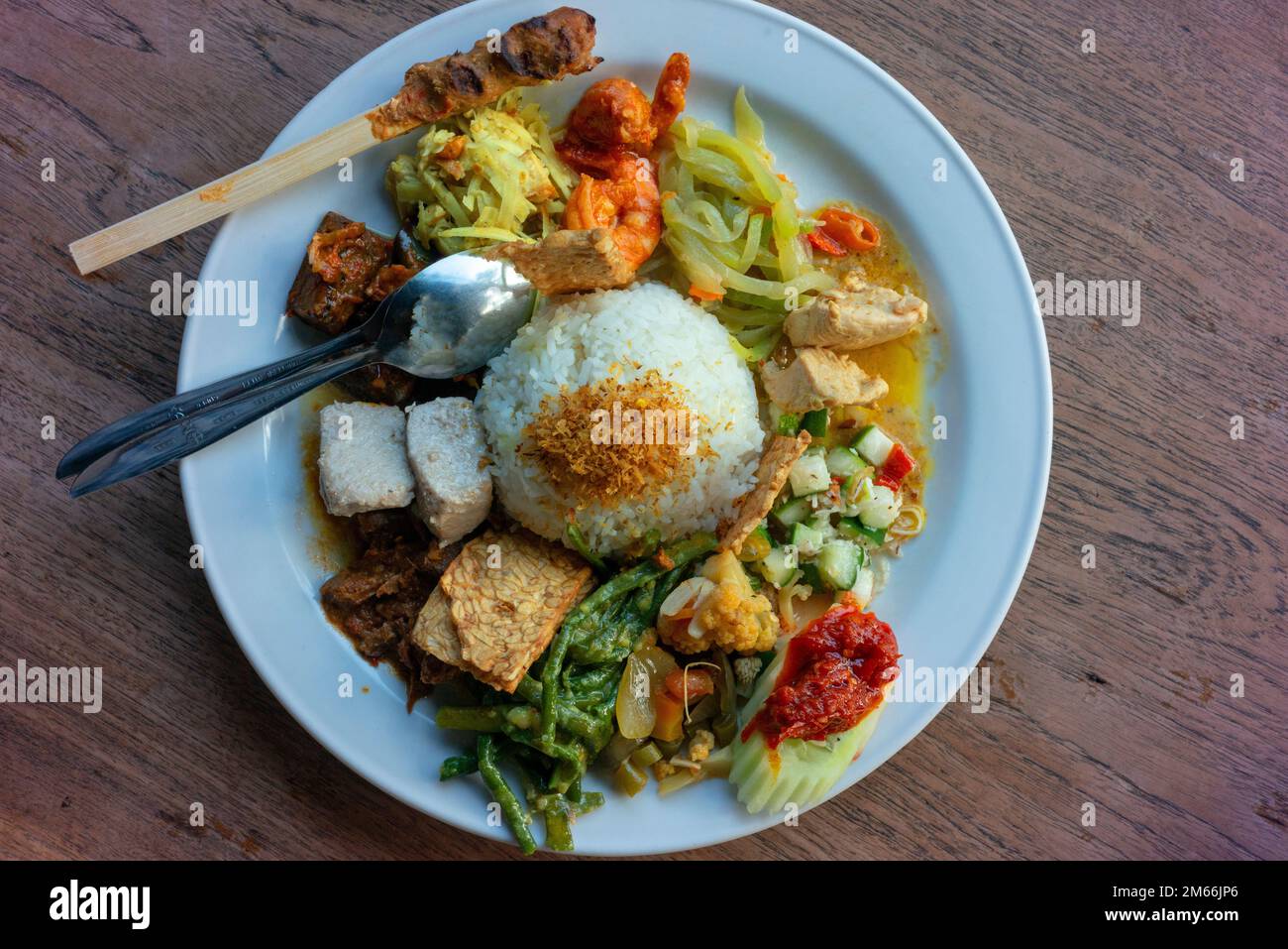 Nasi campur (mixed rice) at a restaurant in Kuta. Stock Photo