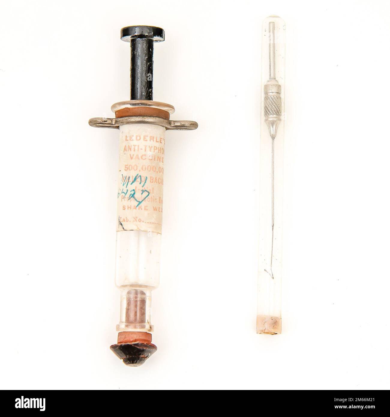 Description: Syringe and Needle    Caption: This is a Lederle Aseptic Anti-Typhoid Syringe, manufactured by E. J. Lederle of New York City. It was acquired by the Army Medical Museum in Washington, D.C., in 1912. The label on the syringe reads, “Lederle’s Anti-Typhoid Vaccine. 1,000,000 killed bacilli 2d of 3d prophylactic dose.” The syringe was patented three years after Capt. Frederick Russell’s clinical trial at the Army Medical Museum, which demonstrated the safety and effectiveness of the vaccine. As a result of the trial, the U.S. Army became the first military to vaccinate against typho Stock Photo