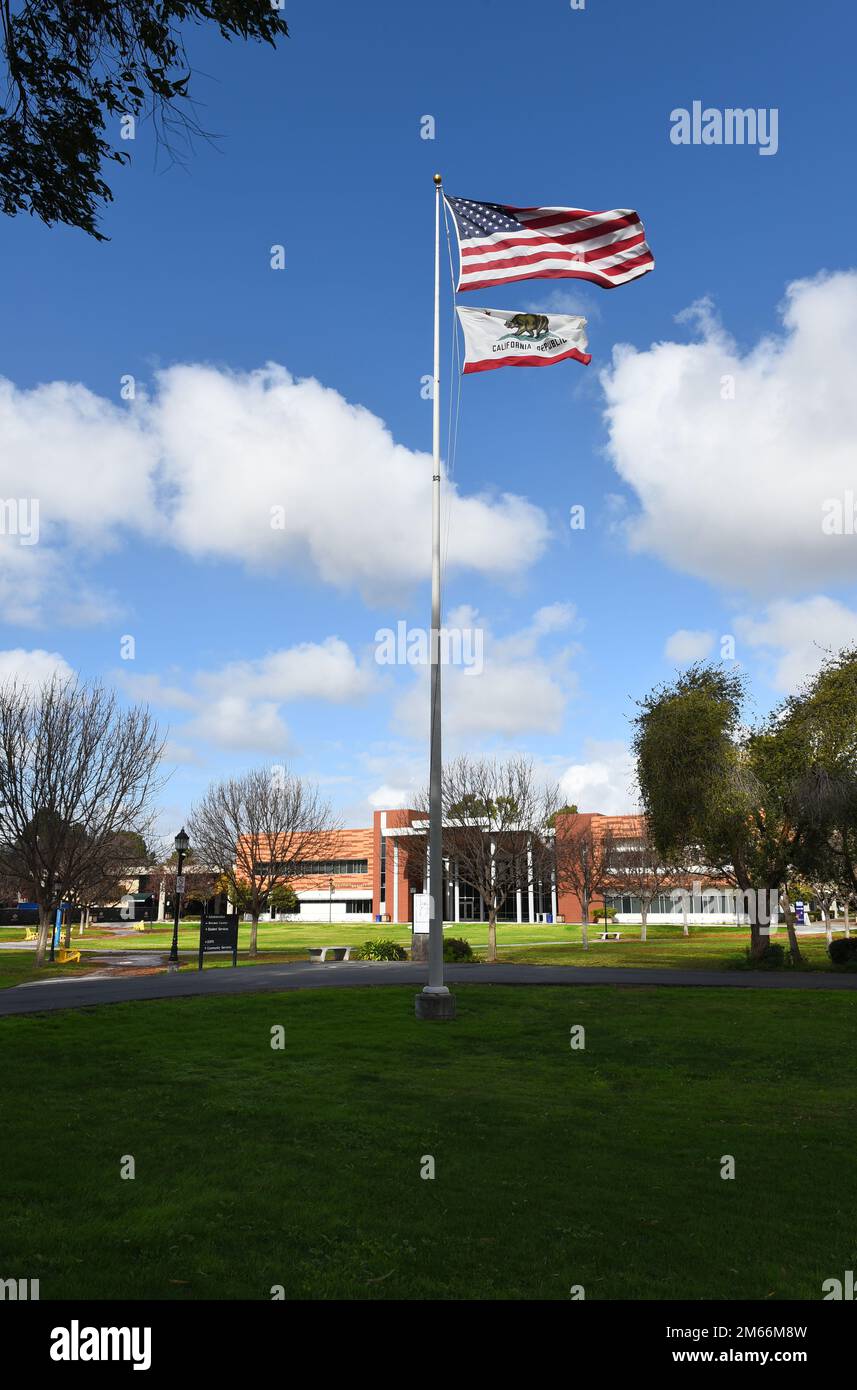 HUNTINGTON BEACH, CALIFORNIA - 01 JAN 2023: Flag and Student Services Center in the main quad on the campus of Golden West College. Stock Photo