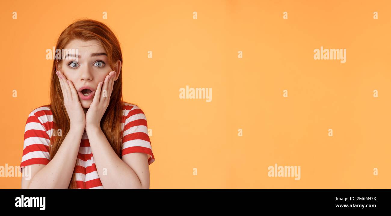Close-up shocked speechless redhead woman, drop jaw gasping, touch ...