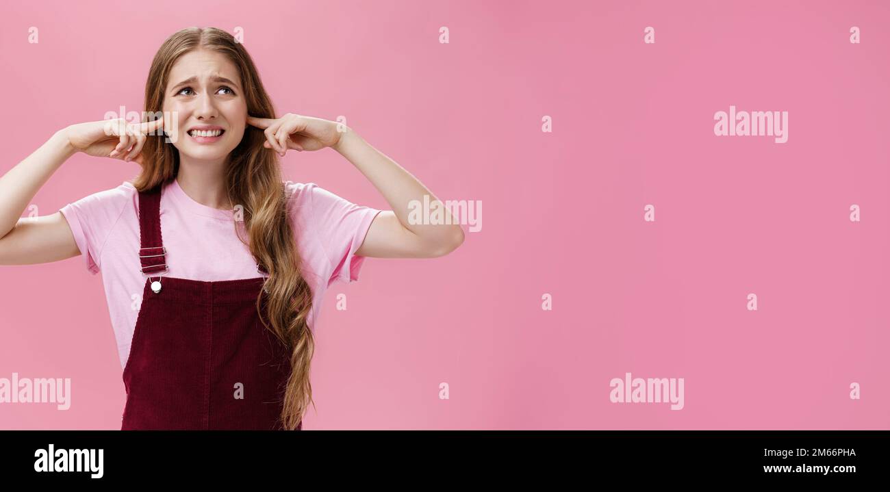 Turn off annoying sound. Young displeased girl feeling from