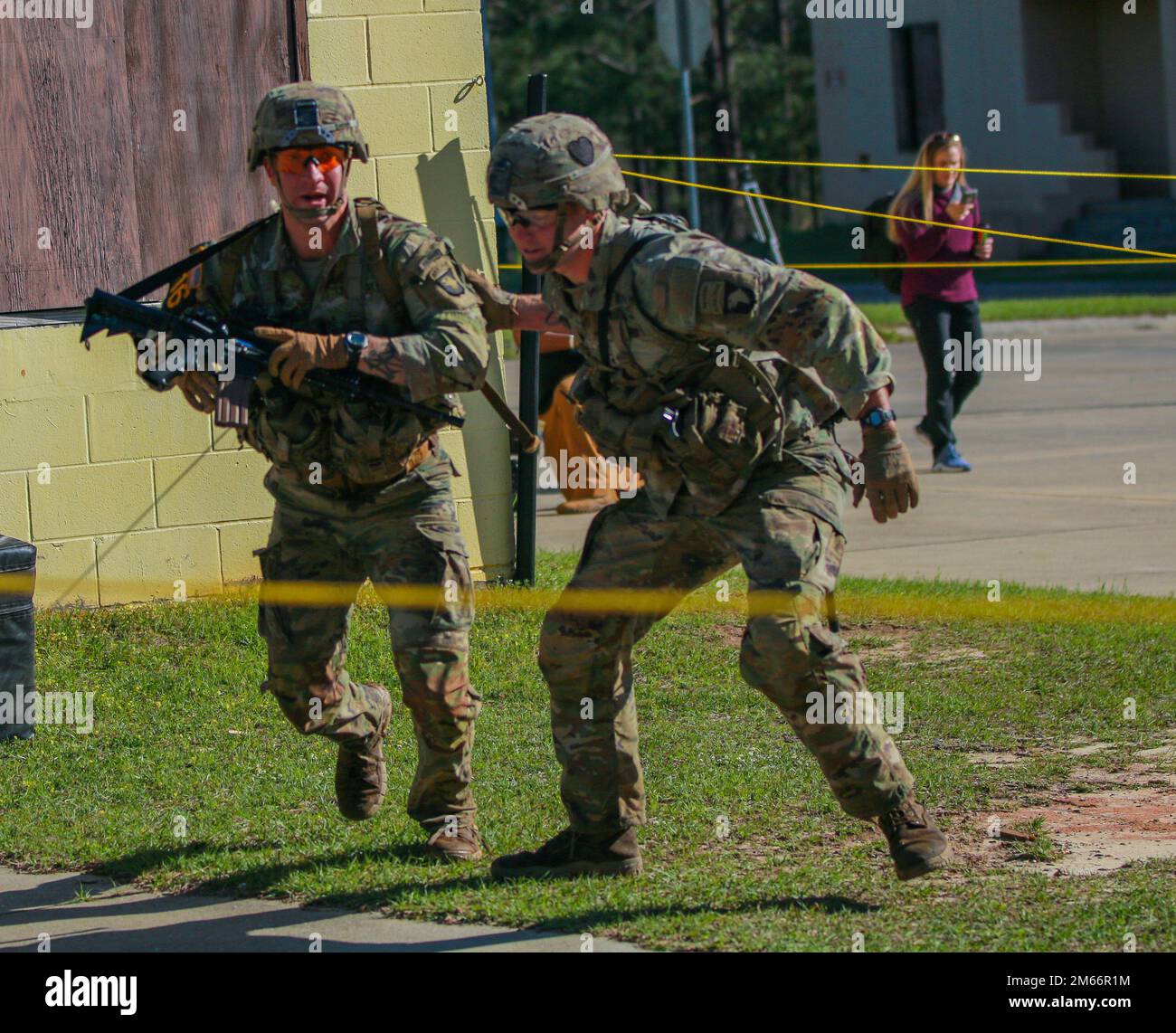 1st Lt. Aaron Arturi (left) and 1st Lt. John Ryan from the 101st Airborne Division (Air Assault),  takes on the Buddy Run event at the Annual Best Ranger Competition in Fort Benning, Ga on April 8th 2022. The Buddy Run event is team oriented, where the group of rangers must work together to execute the event in a timely manner. Stock Photo