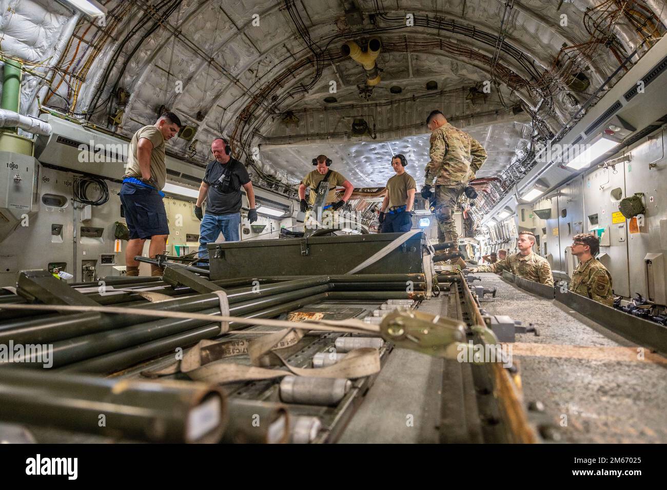 U.S. Airmen assigned to the 60th Aerial Port Squadron and 4th Airlift Squadron load a K-loader onto a C-17 Globemaster III at Travis Air Force Base, California, March 8, 2022. Team Travis’ 60th Aerial Port Squadron integrated with the 4th AS to transport a K-loader to support the US. Navy in a F-35C Lightning II recovery mission. Stock Photo