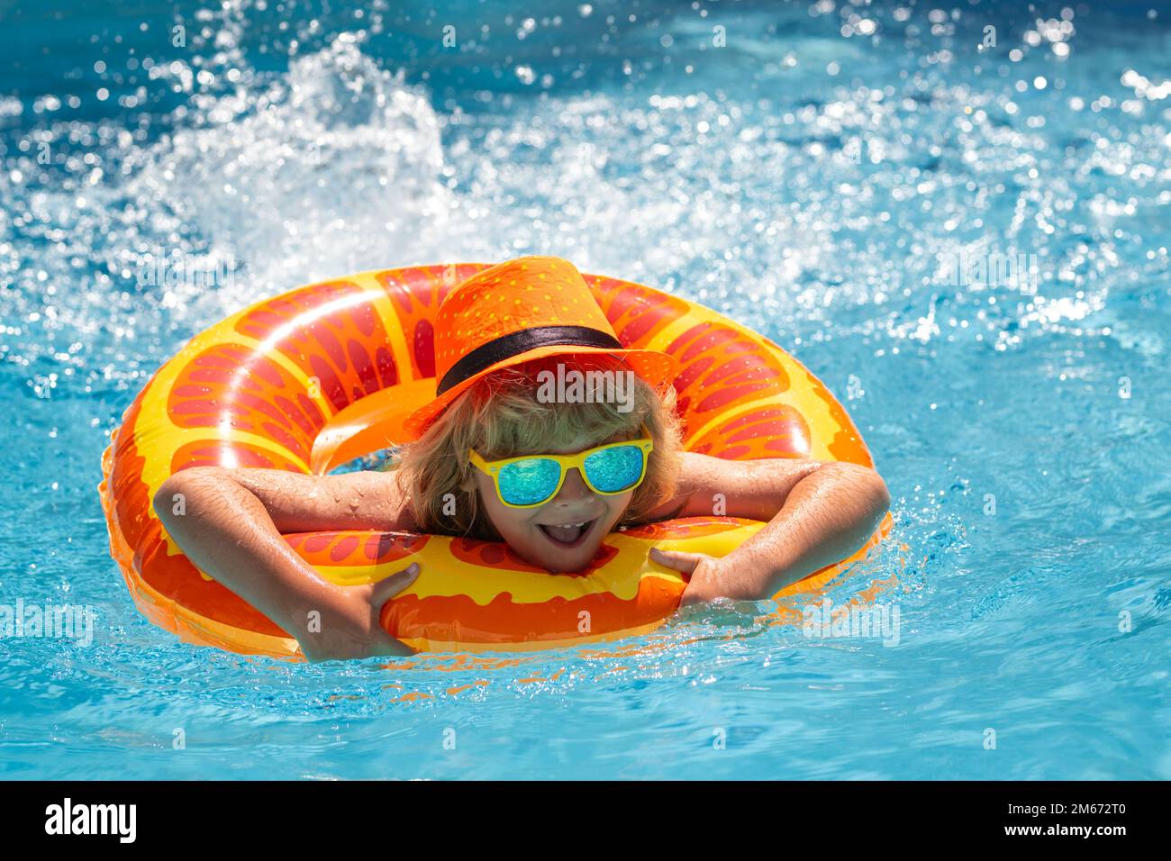 Kid boy relaxing in pool. Child swimming in water pool. Summer kids