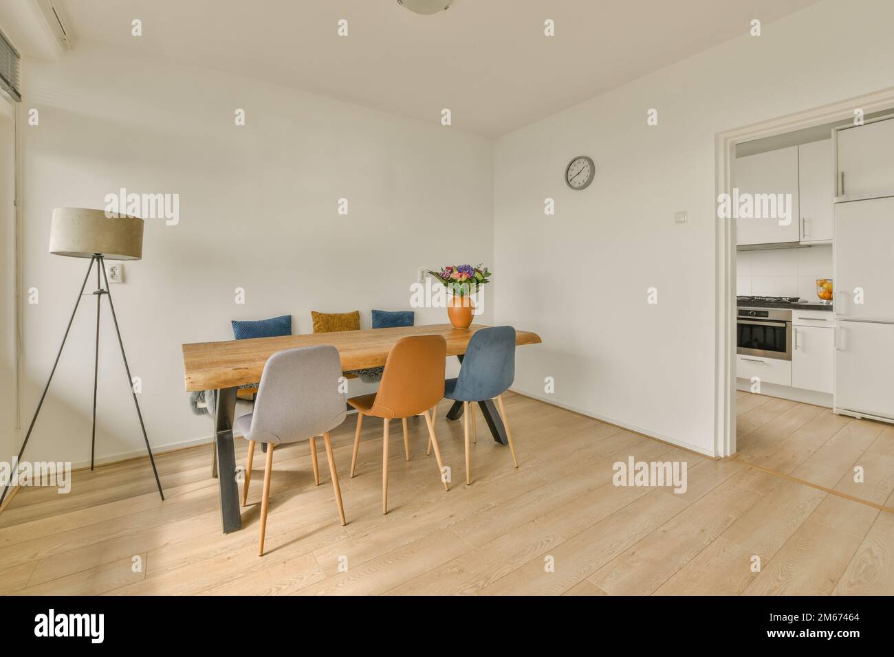 a dining table and chairs in a room with white walls, hardwood flooring ...