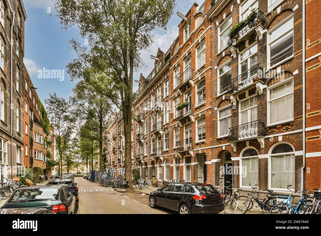 some cars parked on the side of a street in an urban area with many ...