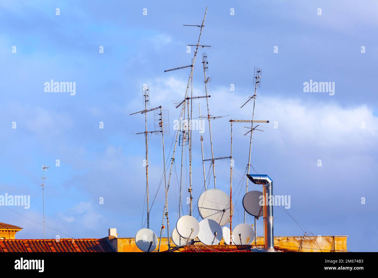 Antennas on an old roof . Rooftop with different antennas Stock Photo