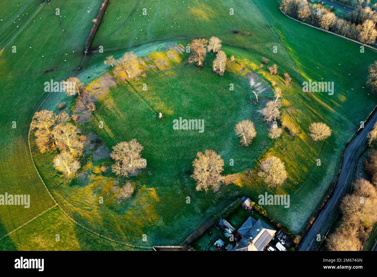Mayburgh Henge prehistoric monument at Eamont Bridge, Cumbria, showing massive circular embankment and remaining central megalith. Aerial winter Stock Photo