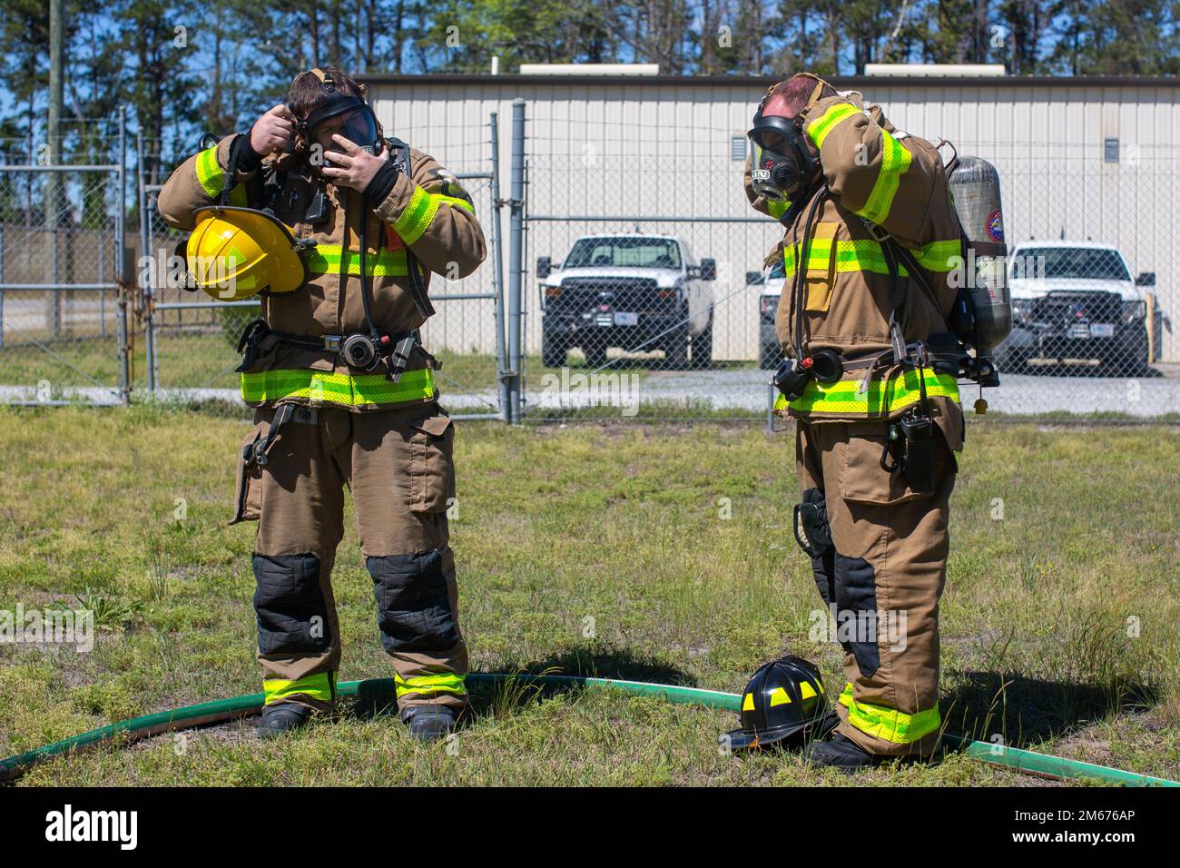 Ethan Harris, left, and Richard Miller, right, both firefighters with