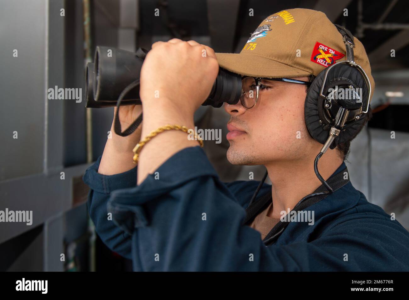220410-N-CY569-1158 IONIAN SEA (April 10, 2022) Seaman Mario Martinez, from Bayamon, Puerto Rico, stands lookout watch on the fantail of the Nimitz-class aircraft carrier USS Harry S. Truman (CVN 75), April 10, 2022. The Harry S. Truman Carrier Strike Group is on a scheduled deployment in the U.S. Sixth Fleet area of operations in support of U.S., allied and partner interests in Europe and Africa. Stock Photo