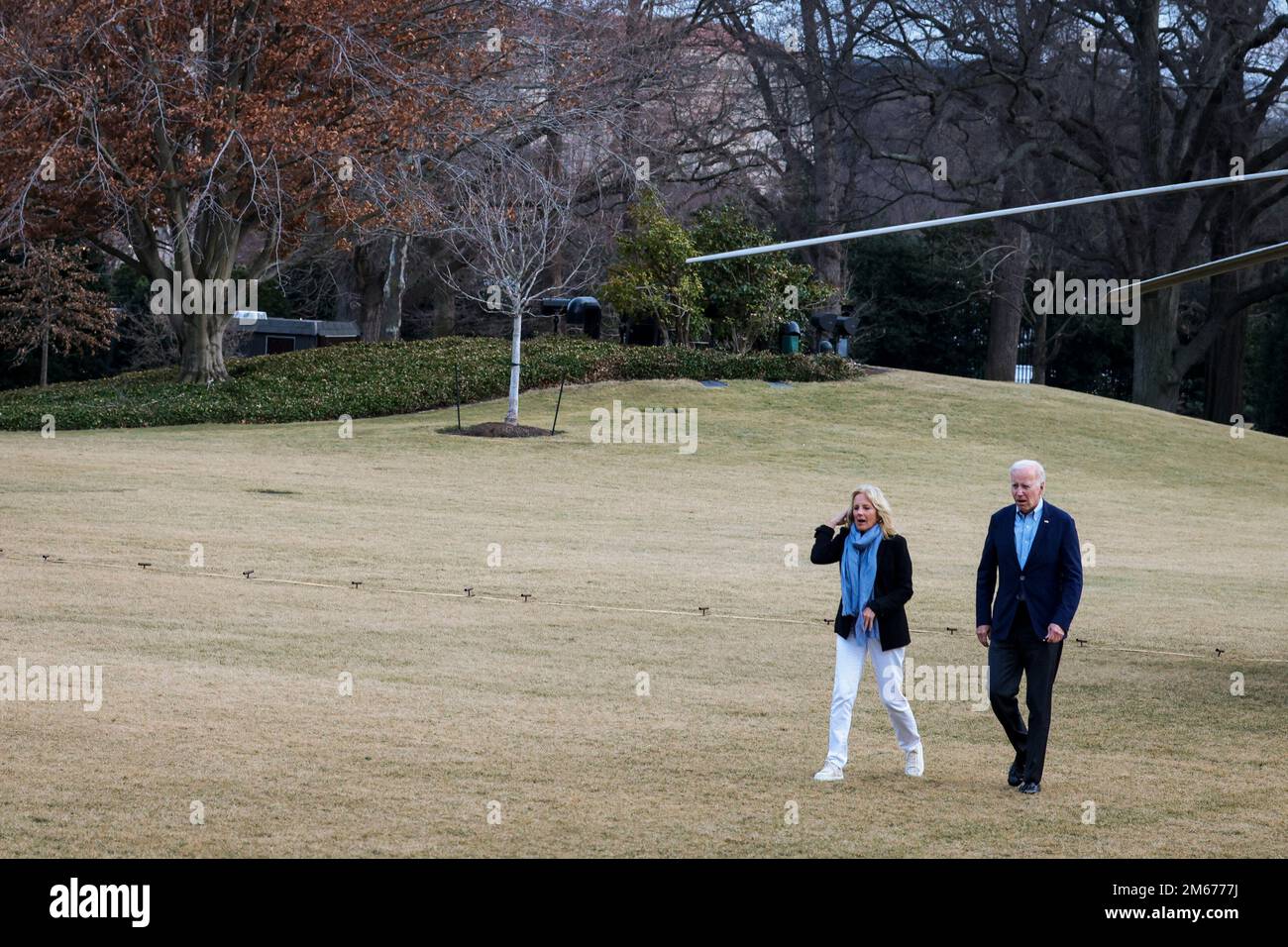 President Joe Biden and first lady Jill Biden walk on the South Lawn as