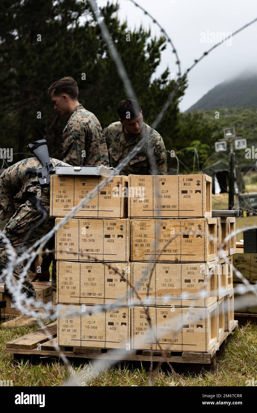 U.S. Marines with Ammunition Company, 3rd Sustainment Group (Experimental), 3rd Marine Logistics Group, establish a field ammunition supply point during a Marine Corps Combat Readiness Evaluation at the Central Training Area in Okinawa, Japan, April 11, 2022. A MCCRE is a formal method of evaluating a unit on its ability to execute its mission essential tasks in a notional combat environment. 3rd MLG, based out of Okinawa, Japan, is a forward-deployed combat unit that serves as III MEF’s comprehensive logistics and combat service support backbone for operations throughout the Indo-Pacific area Stock Photo