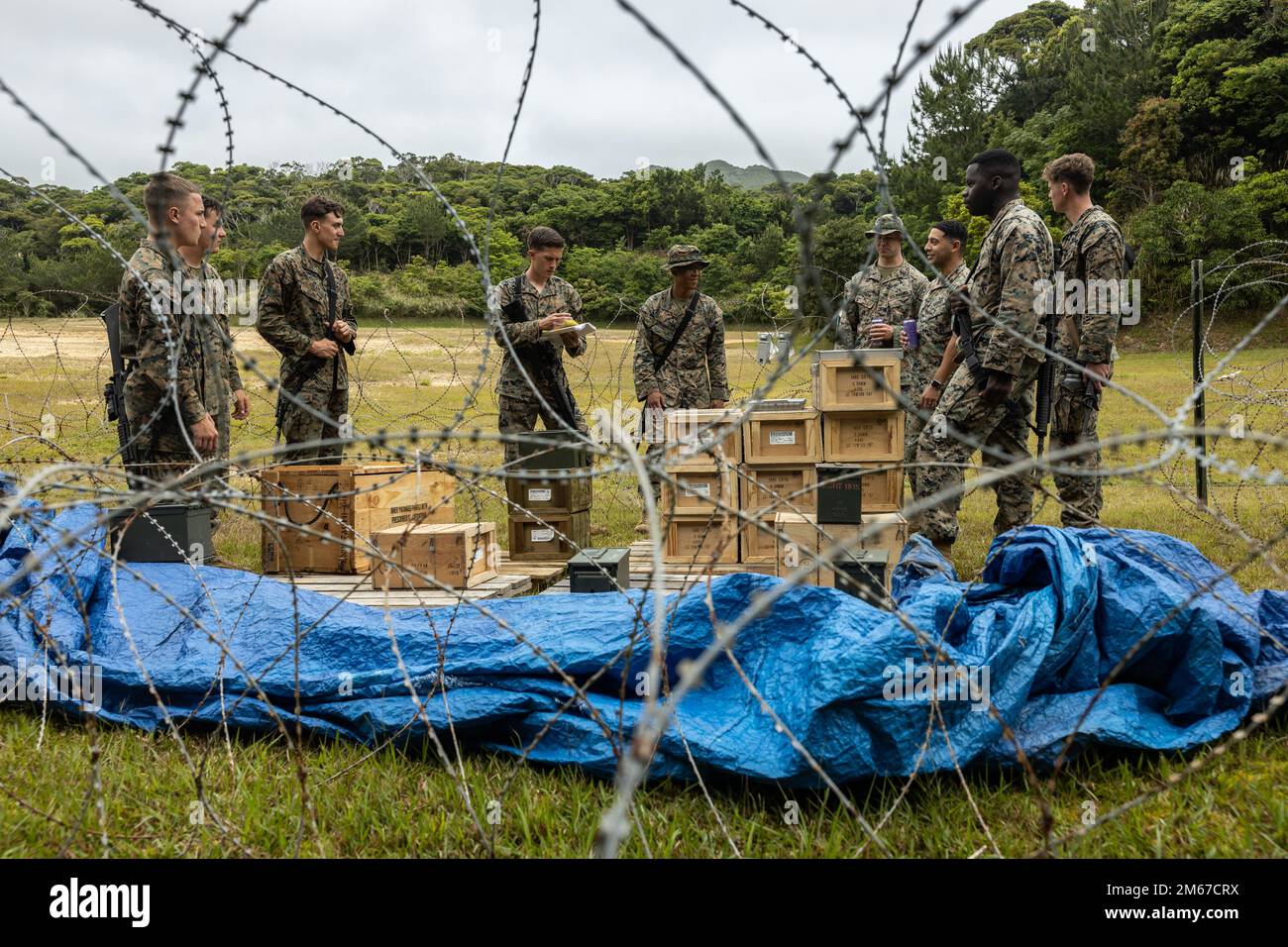 U.S. Marines with Ammunition Company, 3rd Sustainment Group (Experimental), 3rd Marine Logistics Group, are evaluated on their field ammunition supply point during a Marine Corps Combat Readiness Evaluation at the Central Training Area in Okinawa, Japan, April 11, 2022.  A MCCRE is a formal method of evaluating a unit on its ability to execute its mission essential tasks in a notional combat environment. 3rd MLG, based out of Okinawa, Japan, is a forward-deployed combat unit that serves as III MEF’s comprehensive logistics and combat service support backbone for operations throughout the Indo- Stock Photo