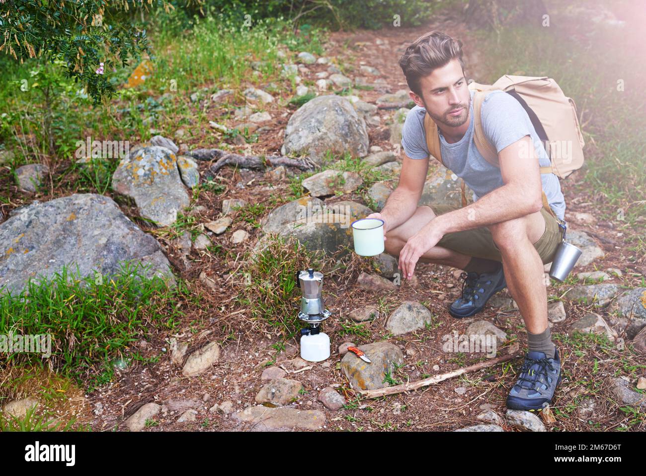 Adventure begins after coffee. a handsome hiker having coffee. Stock Photo