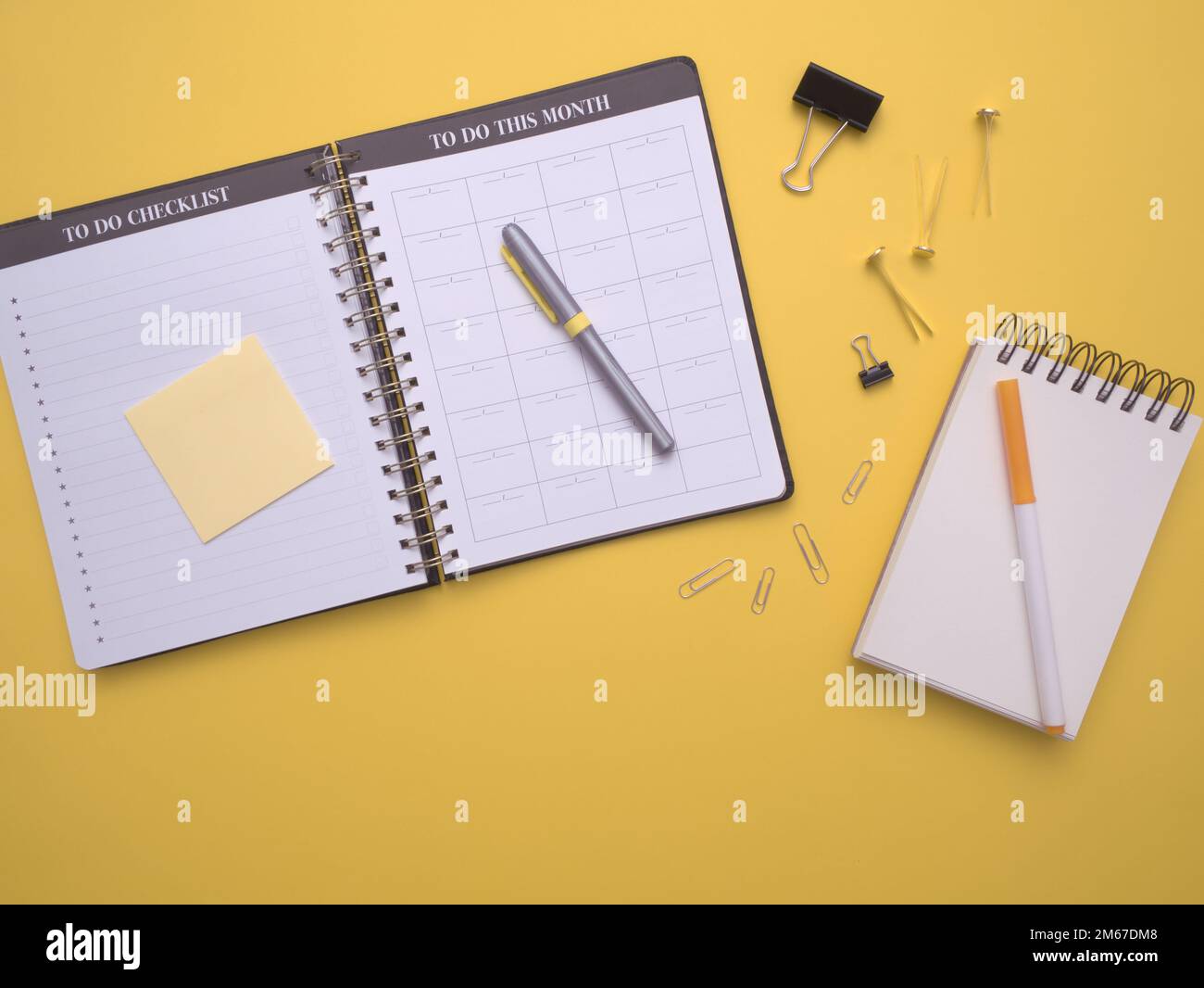 overhead-flat-lay-workspace-with-a-calendar-planner-notebook-pens