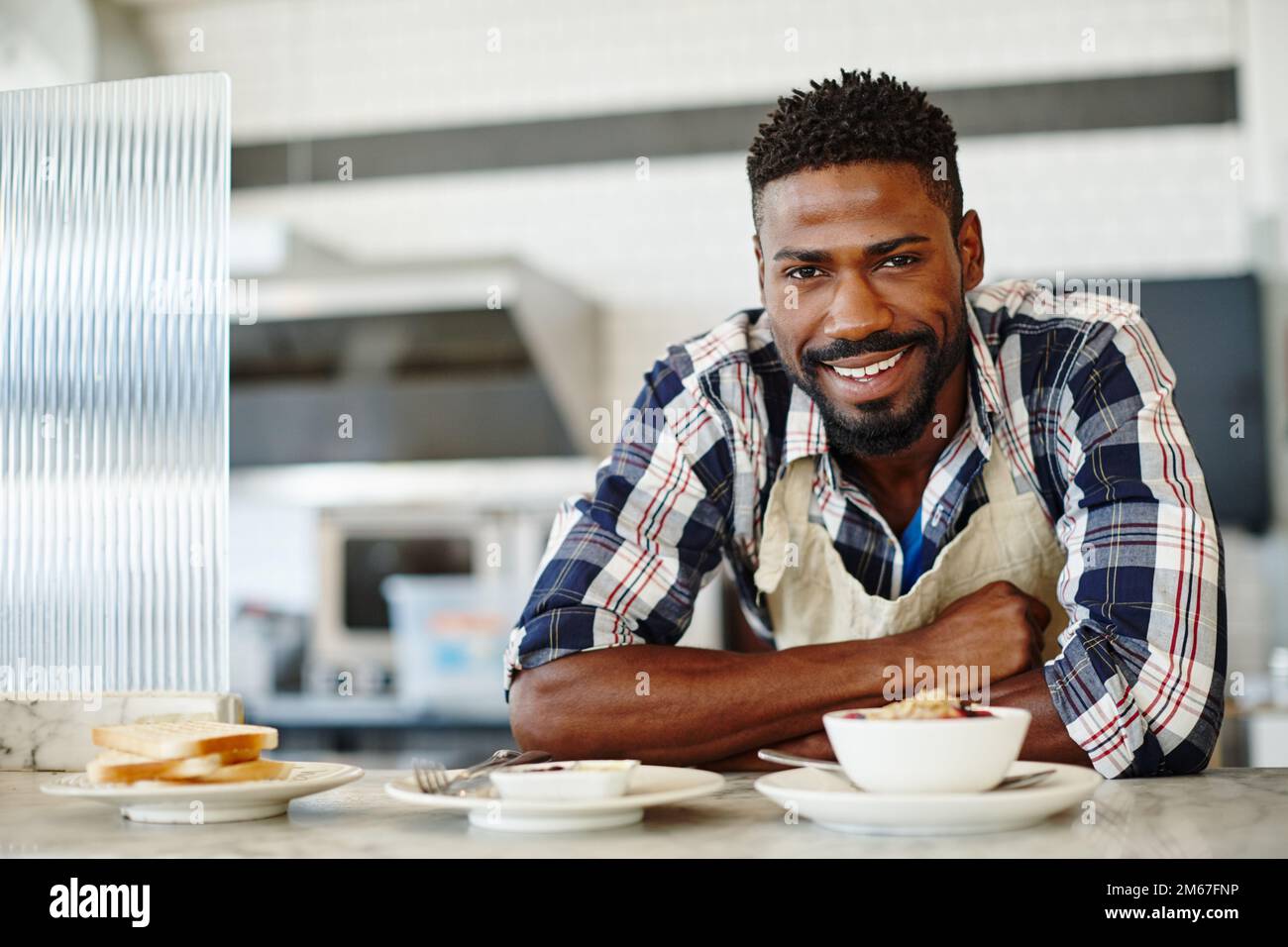 Start your day with a healthy breakfast. Cropped portrait of a handsome young man working in a coffee shop. Stock Photo