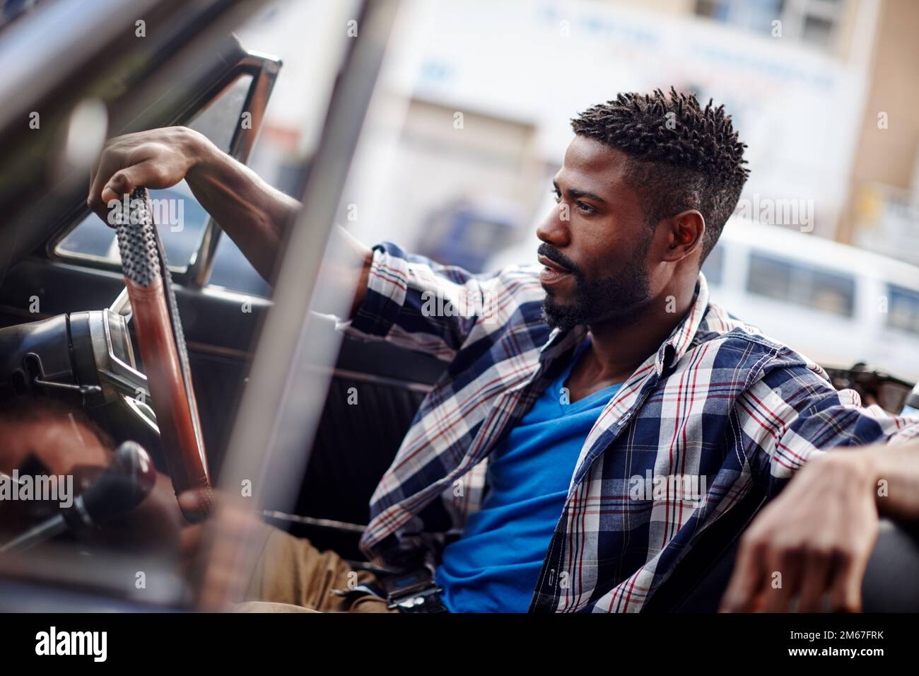 Were all explorers trying to find ourselves. A handsome young man driving in his convertible. Stock Photo