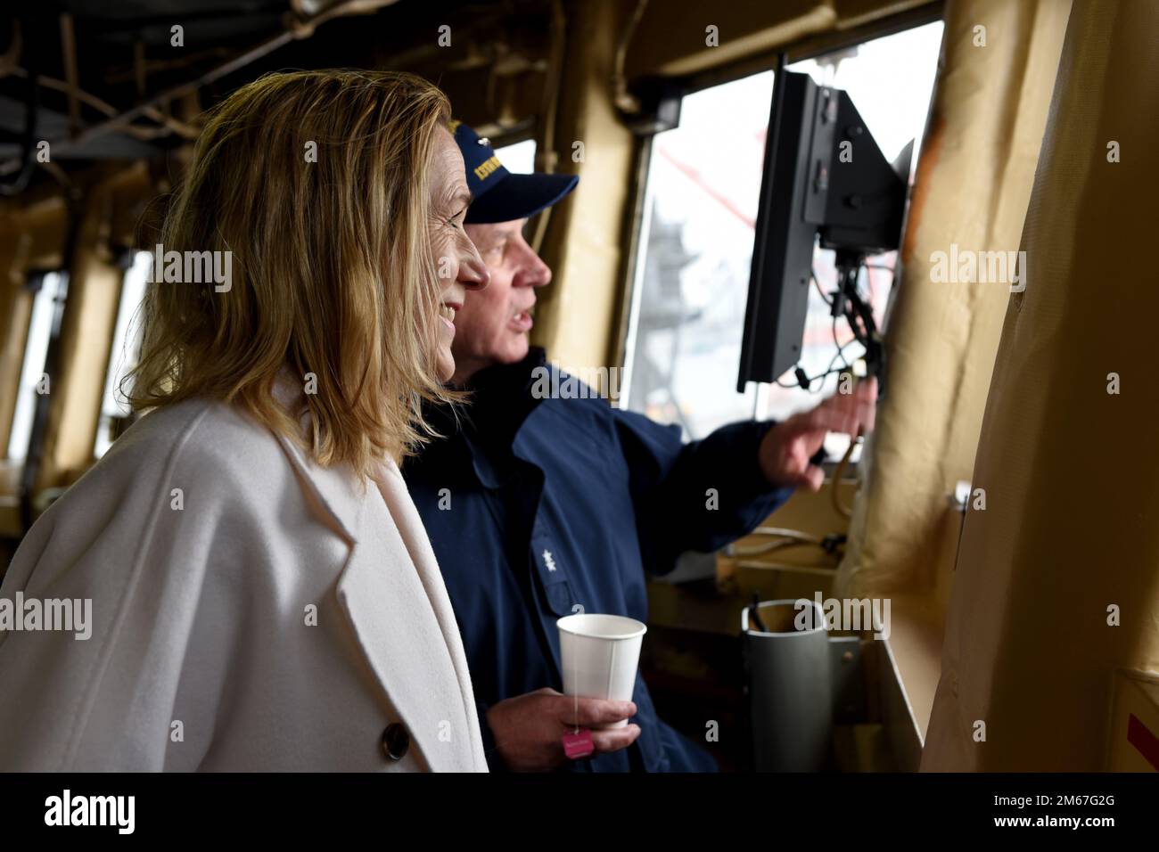 Kirsten Hillman, Canadian Ambassador to the United States, and Rear Adm. Melvin Bouboulis, commander of the 13th Coast Guard District, observe the Base Seattle grounds from the bridge of Coast Guard Cutter Healy (WAGB-20) Tuesday, April 12. Ambassador Hillman toured the Healy at the Base Seattle pier after attending the Arctic Encounter Symposium in Anchorage, AK, days prior. Stock Photo