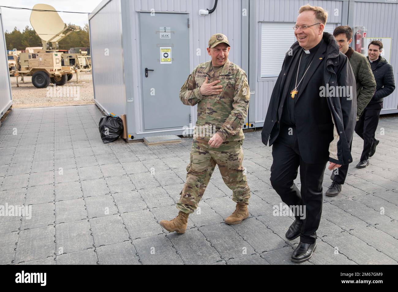 U.S. Army Lt. Col. Paul Godson, commander of 3rd Battalion, 66th Armored Regiment, 1st Infantry Division, gives Lithuanian Archbishop Gintaras Grušas a tour of Camp Herkus, Lithuania, April 12, 2022. Stock Photo