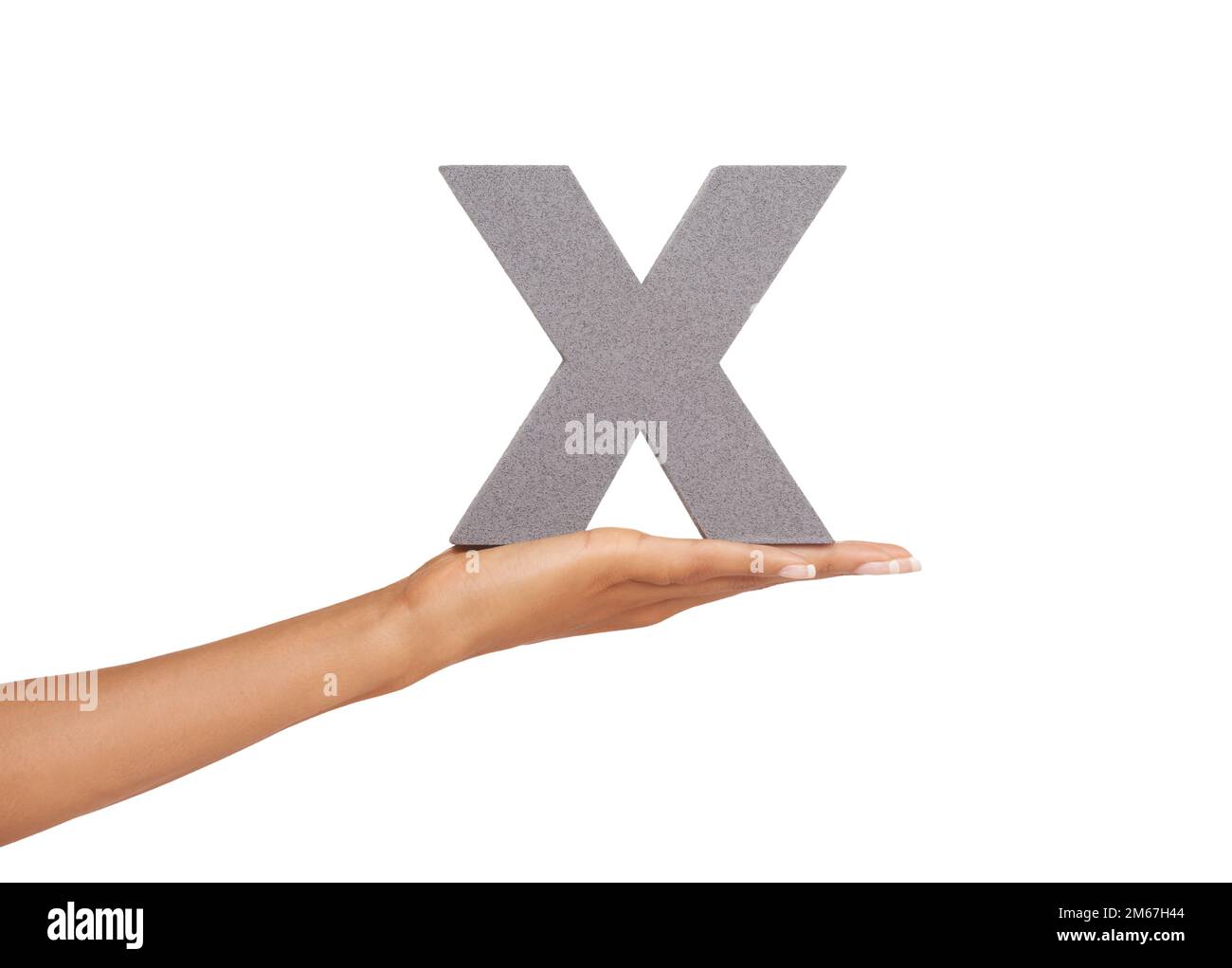 X-amine this letter. A young woman holding a capital letter X isolated on a white background. Stock Photo
