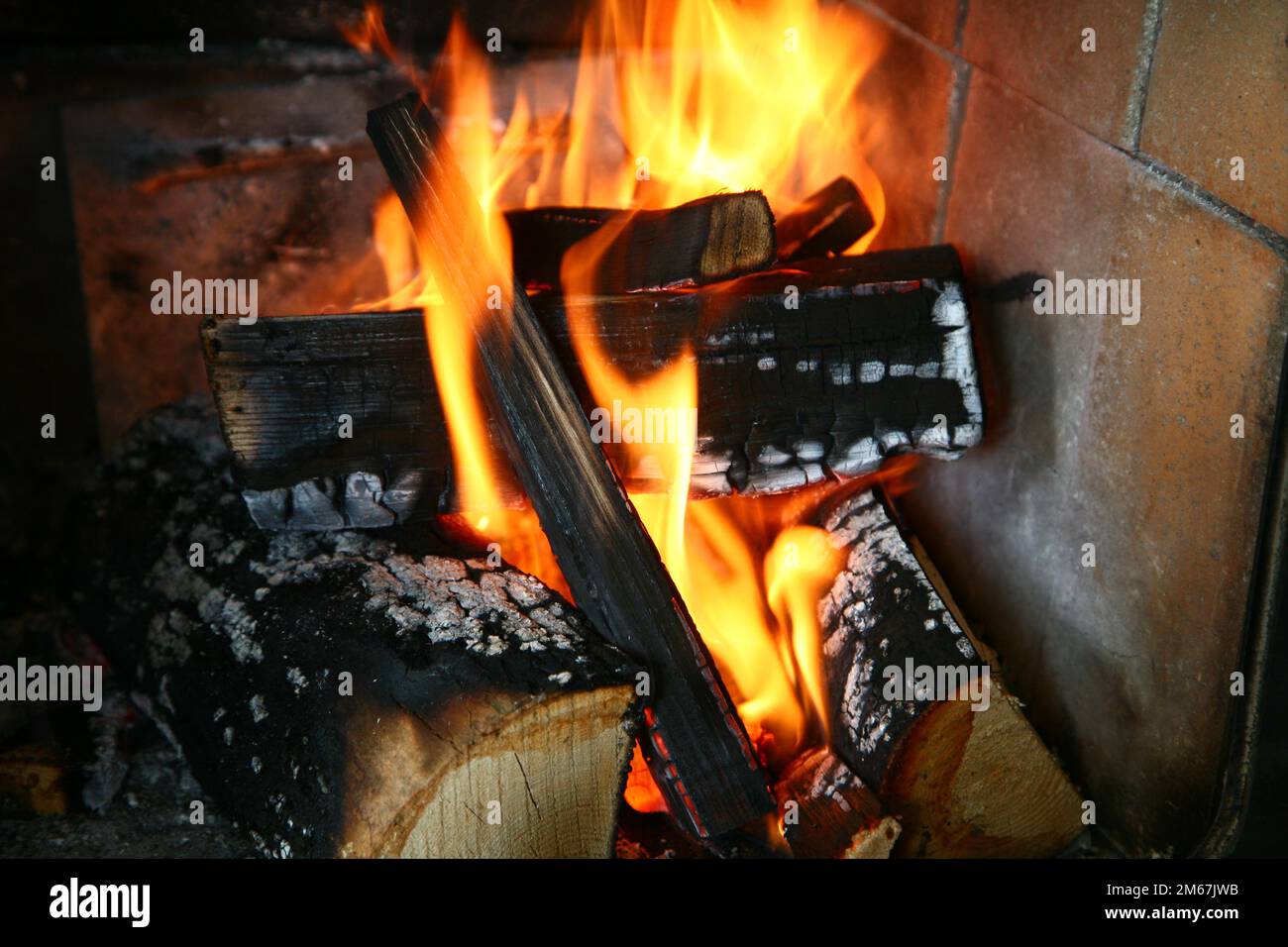Fire and flame in a stove with wood burning Stock Photo - Alamy