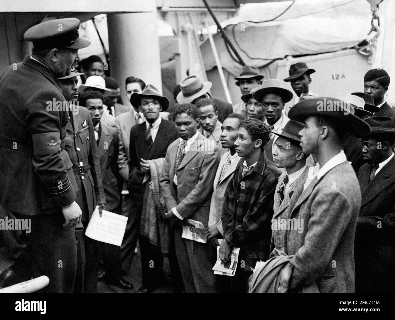 File photo dated 22/06/48 of Jamaican immigrants welcomed by RAF officials from the Colonial Office after the ex-troopship HMT 'Empire Windrush' landed them at Tilbury. The 75th anniversary of the Windrush generation who helped rebuild post-war Britain will be marked later this year as a 'diamond jubilee for modern, diverse Britain', campaigners have said. The Windrush 75 network of national organisations, including British Future charity, which aims to advance racial and cultural harmony in the UK through education, is co-ordinating events to celebrate the historic milestone. Issue date: Tues Stock Photo