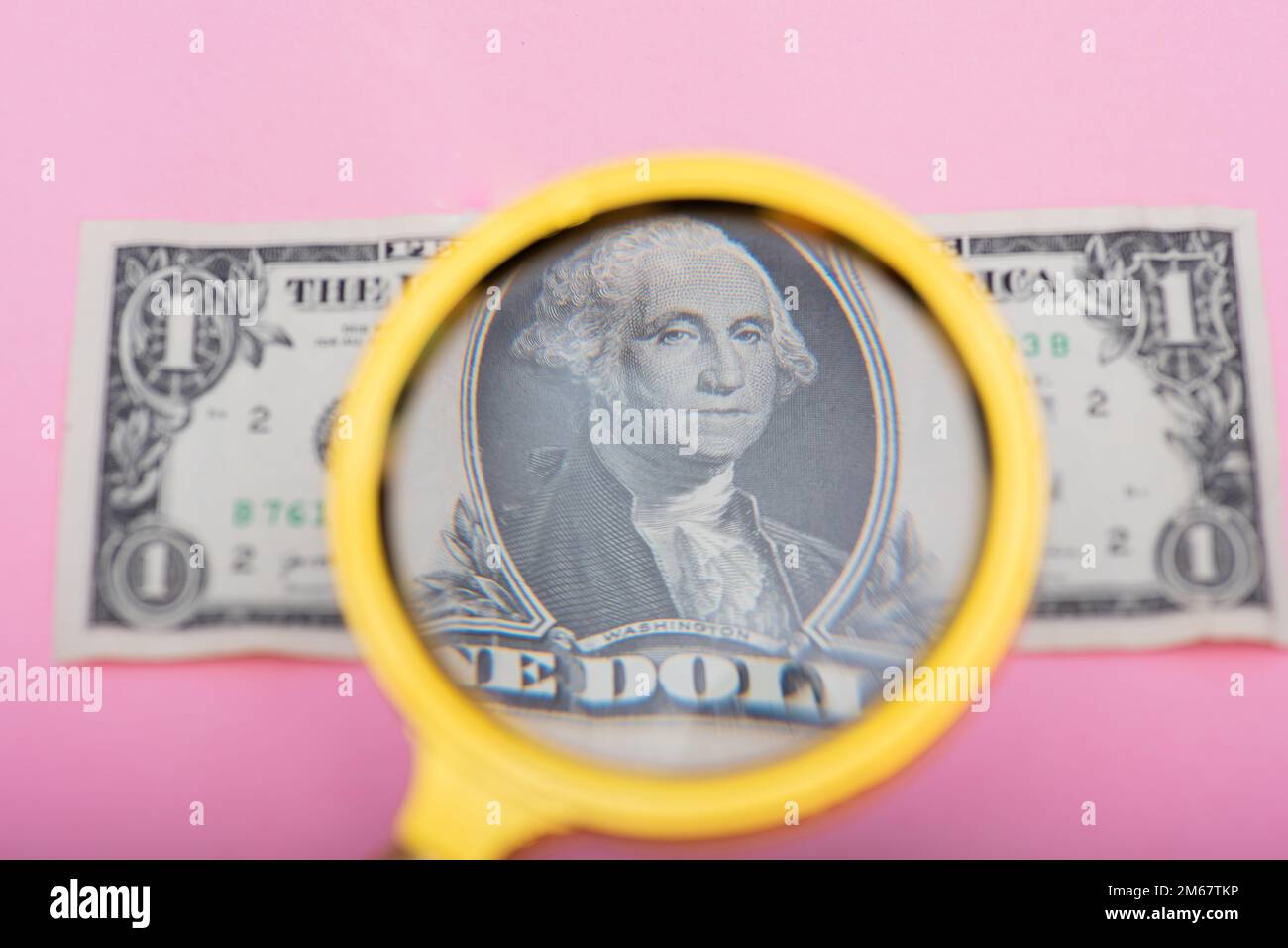 Magnifying glass focusing on dollar bill Stock Photo Alamy